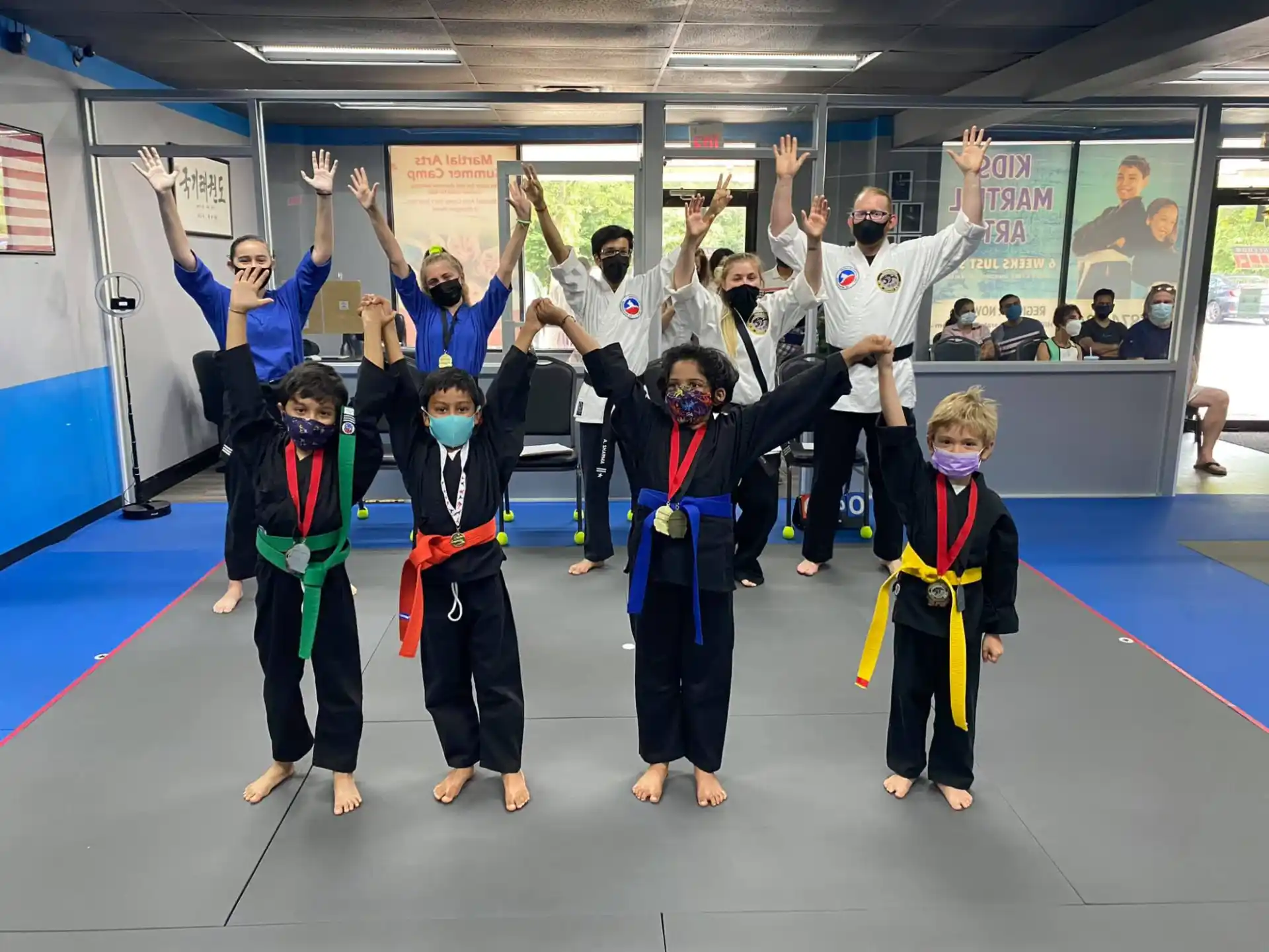 a group of children in karate uniforms