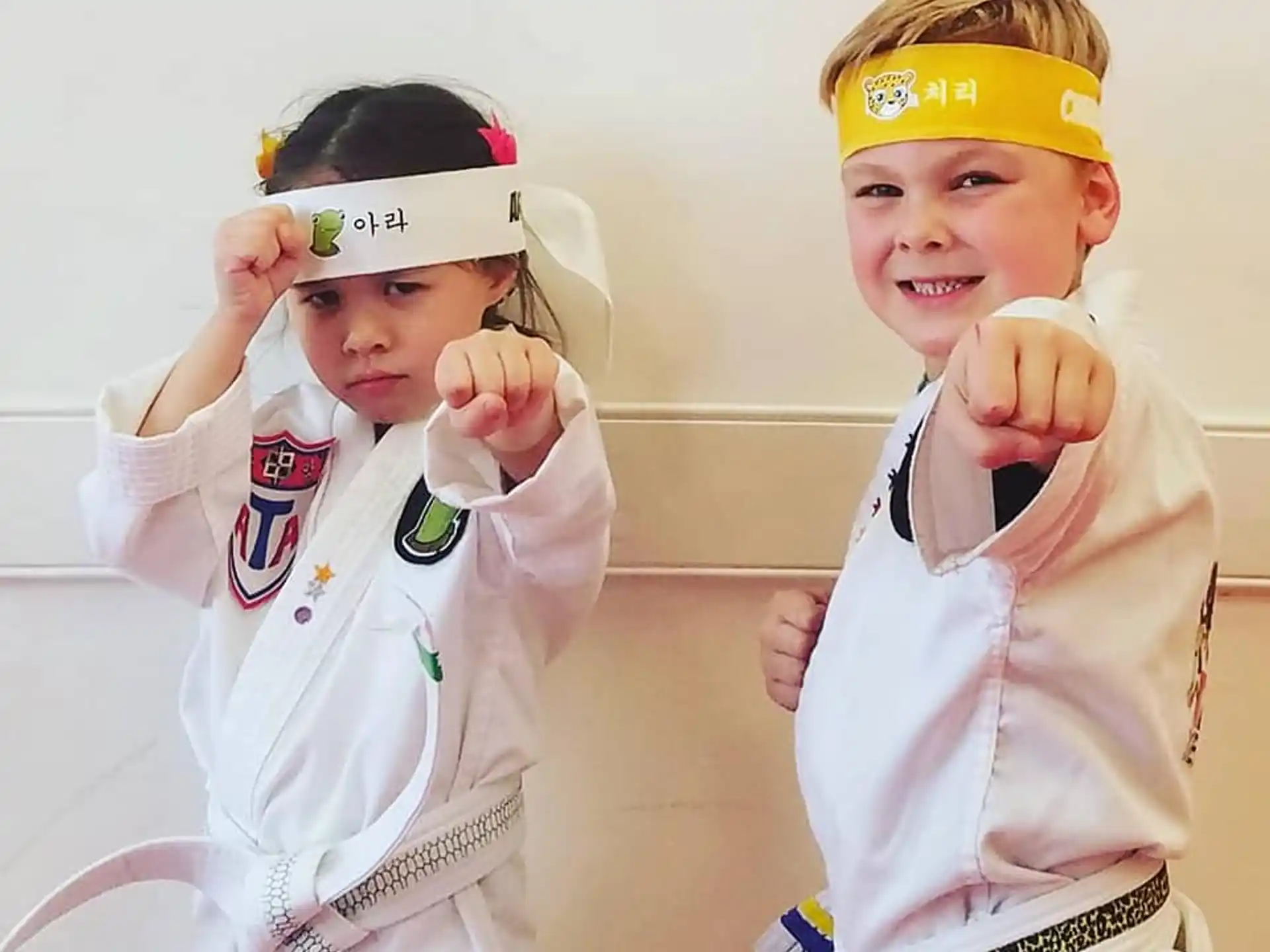 a couple of kids wearing white uniforms