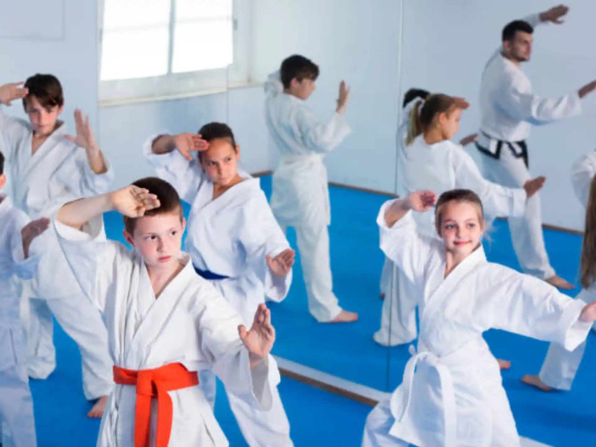 a group of people in white karate uniforms