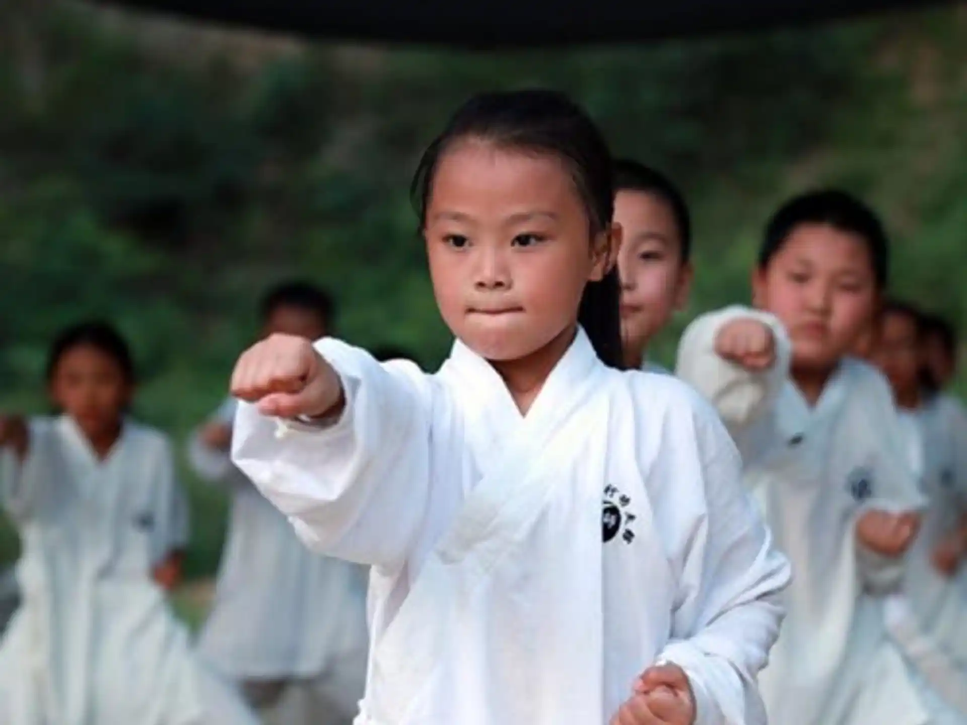 a group of people in karate uniforms