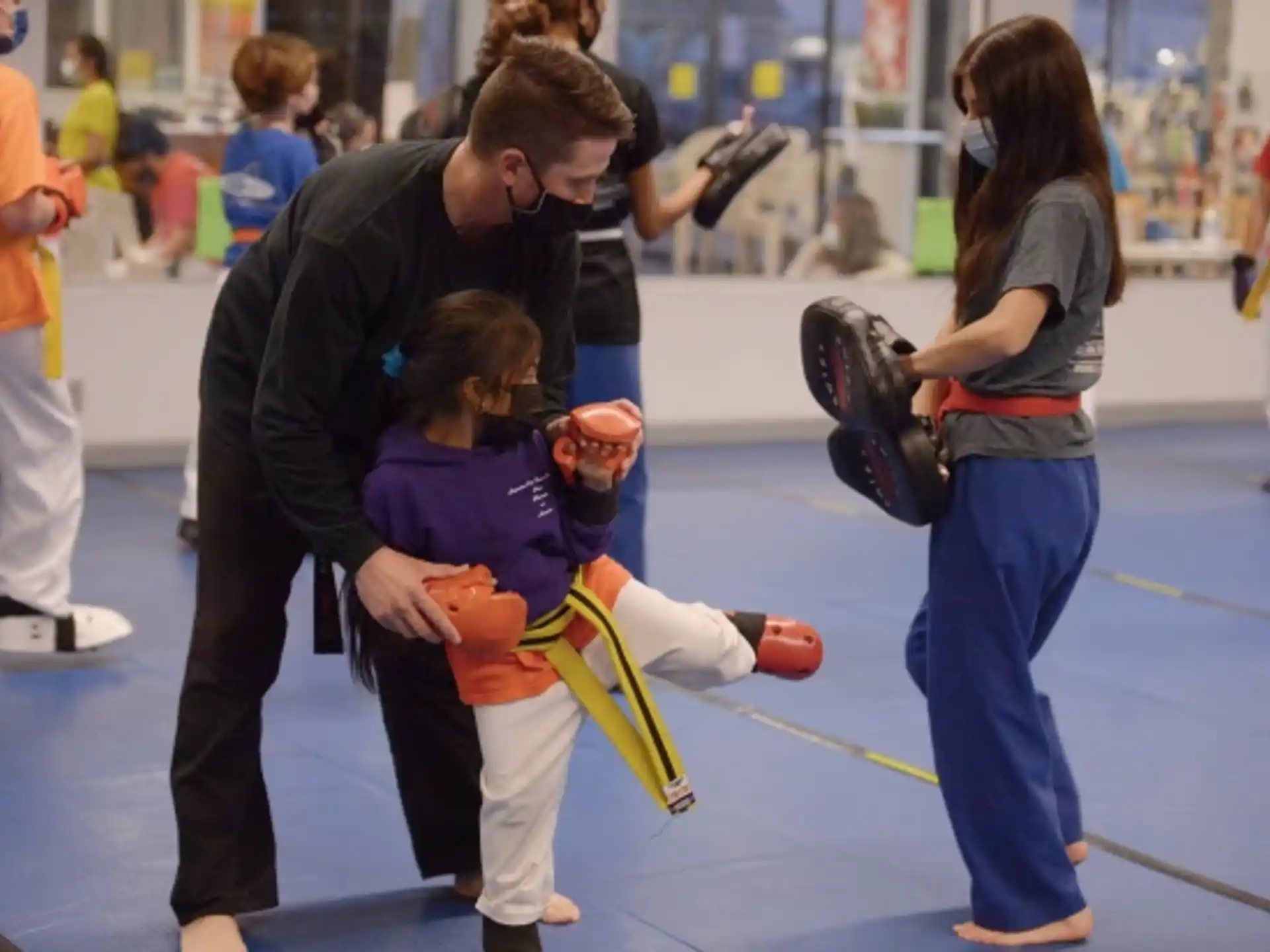 a person helping a girl with a rope