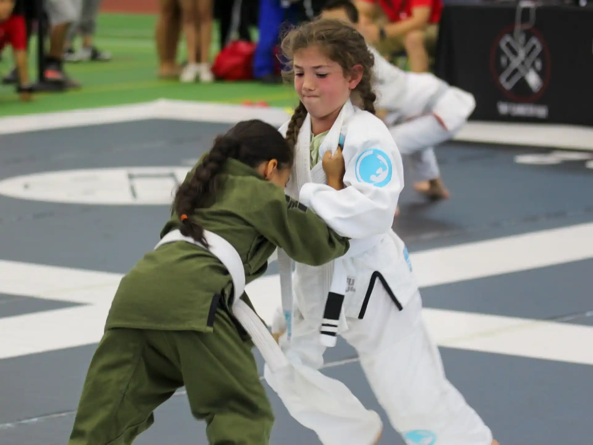 a couple of women in karate uniforms