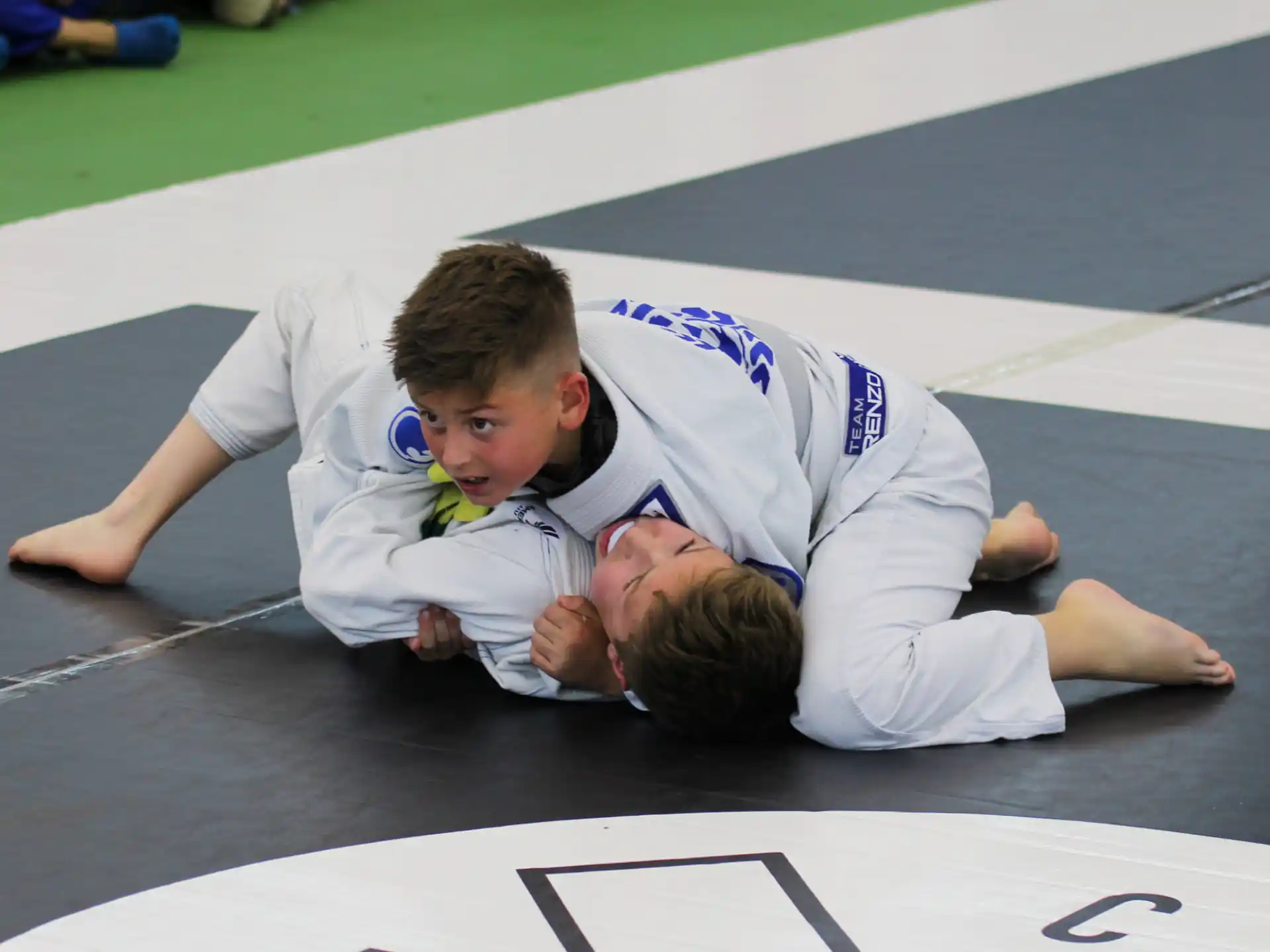 a person and a boy lying on the ground