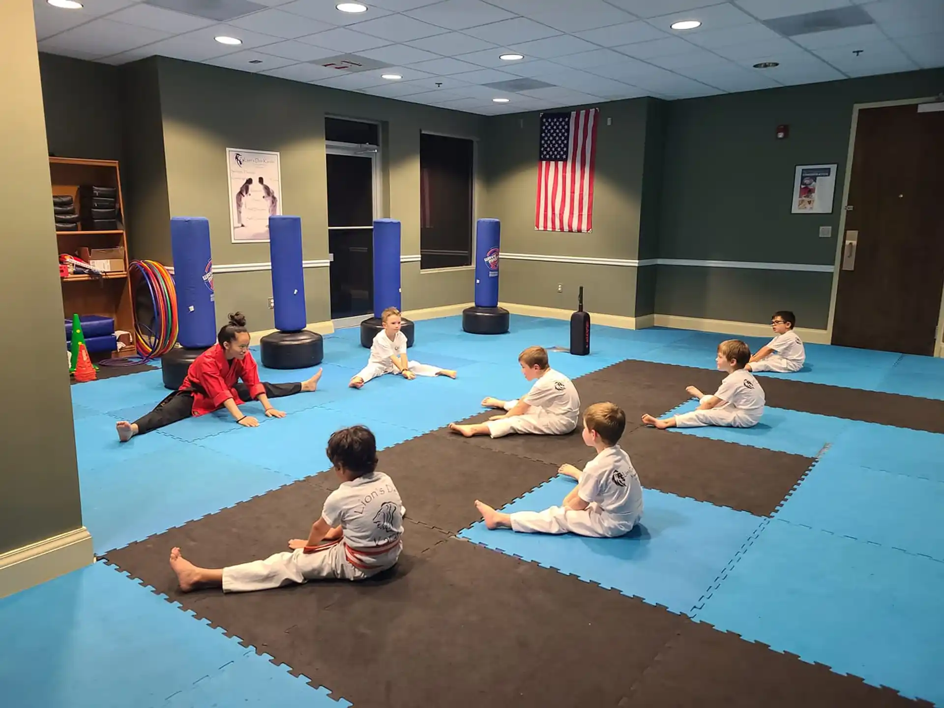 a group of children sitting on the floor in a room