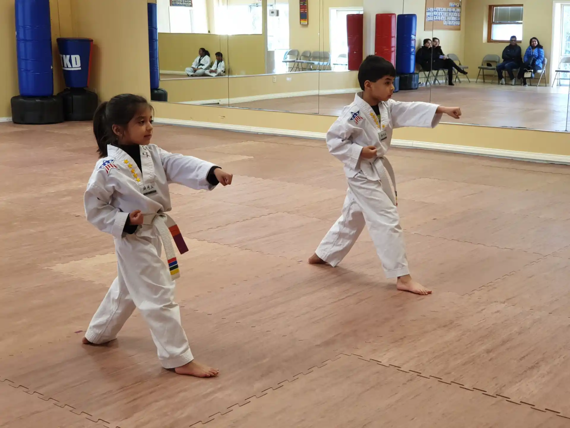 a couple of children in karate uniforms