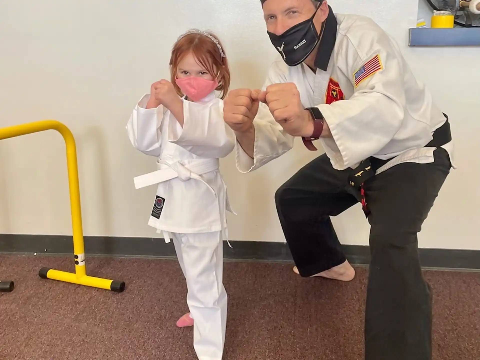 a person and a child in a karate uniform