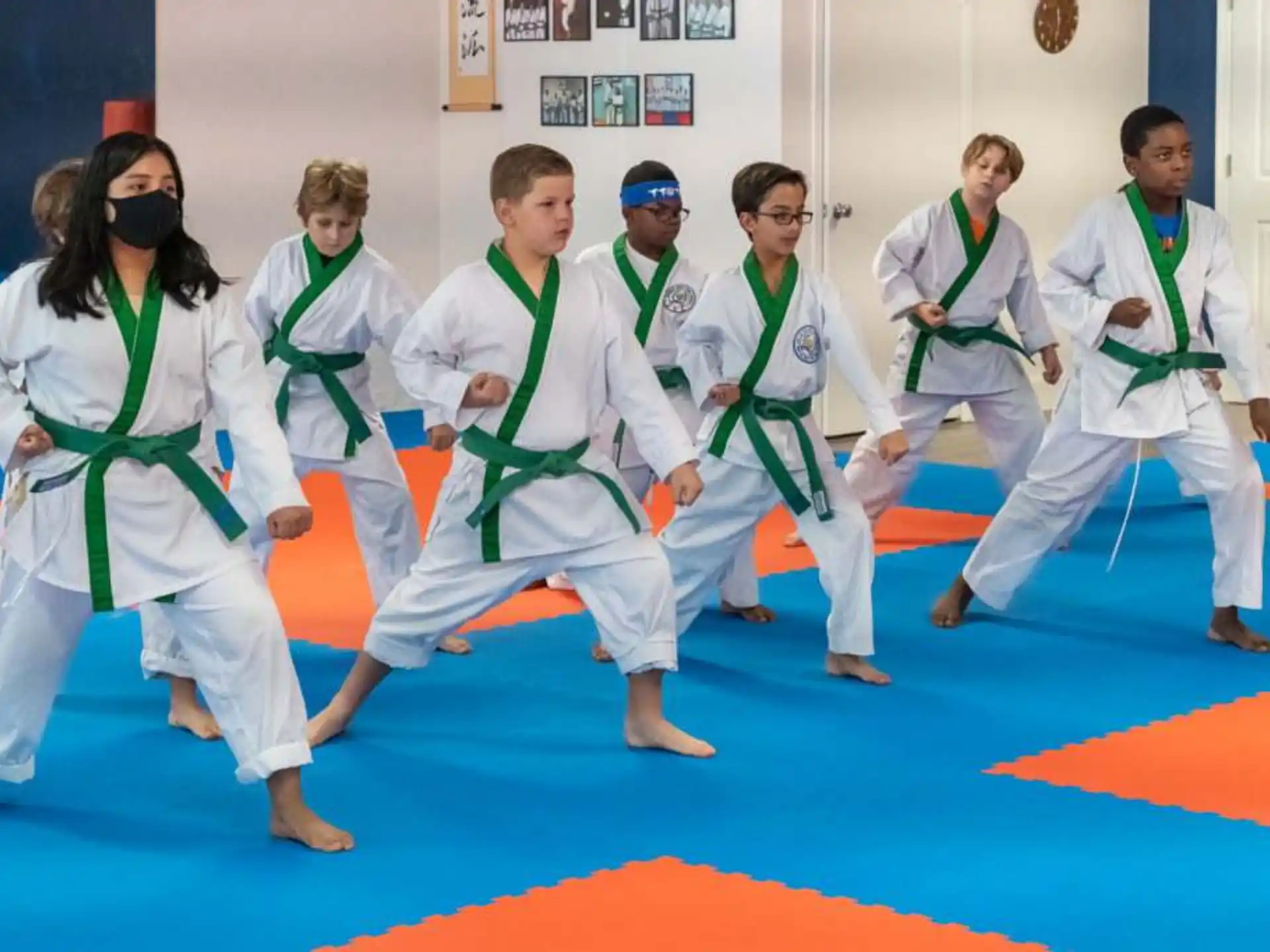 a group of people in white karate uniforms
