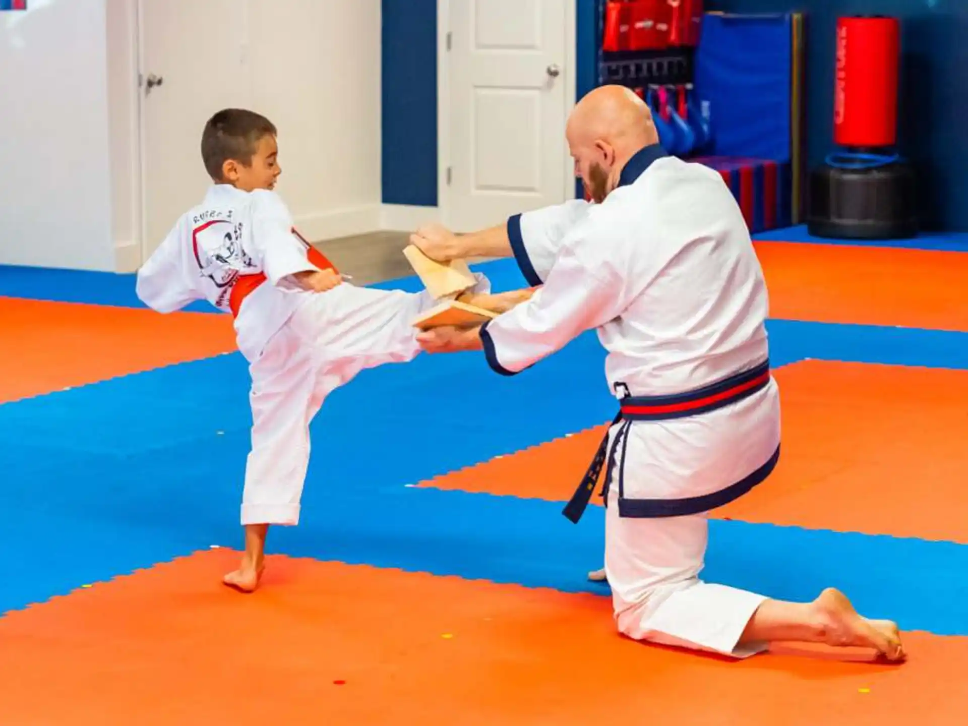 a man and a boy in karate uniforms