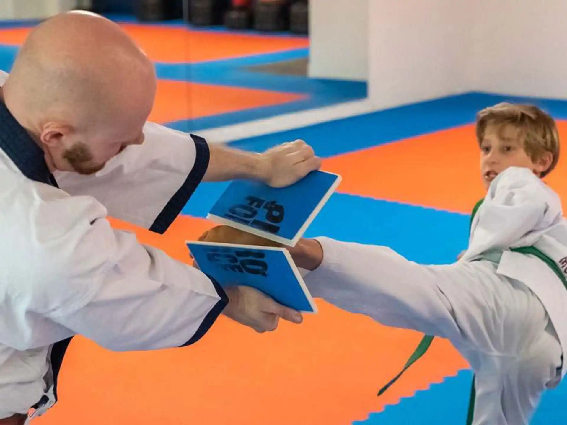a man showing a boy something on a tablet