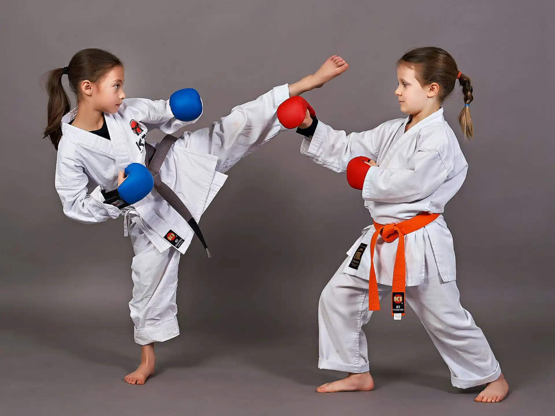 a group of girls in karate uniforms