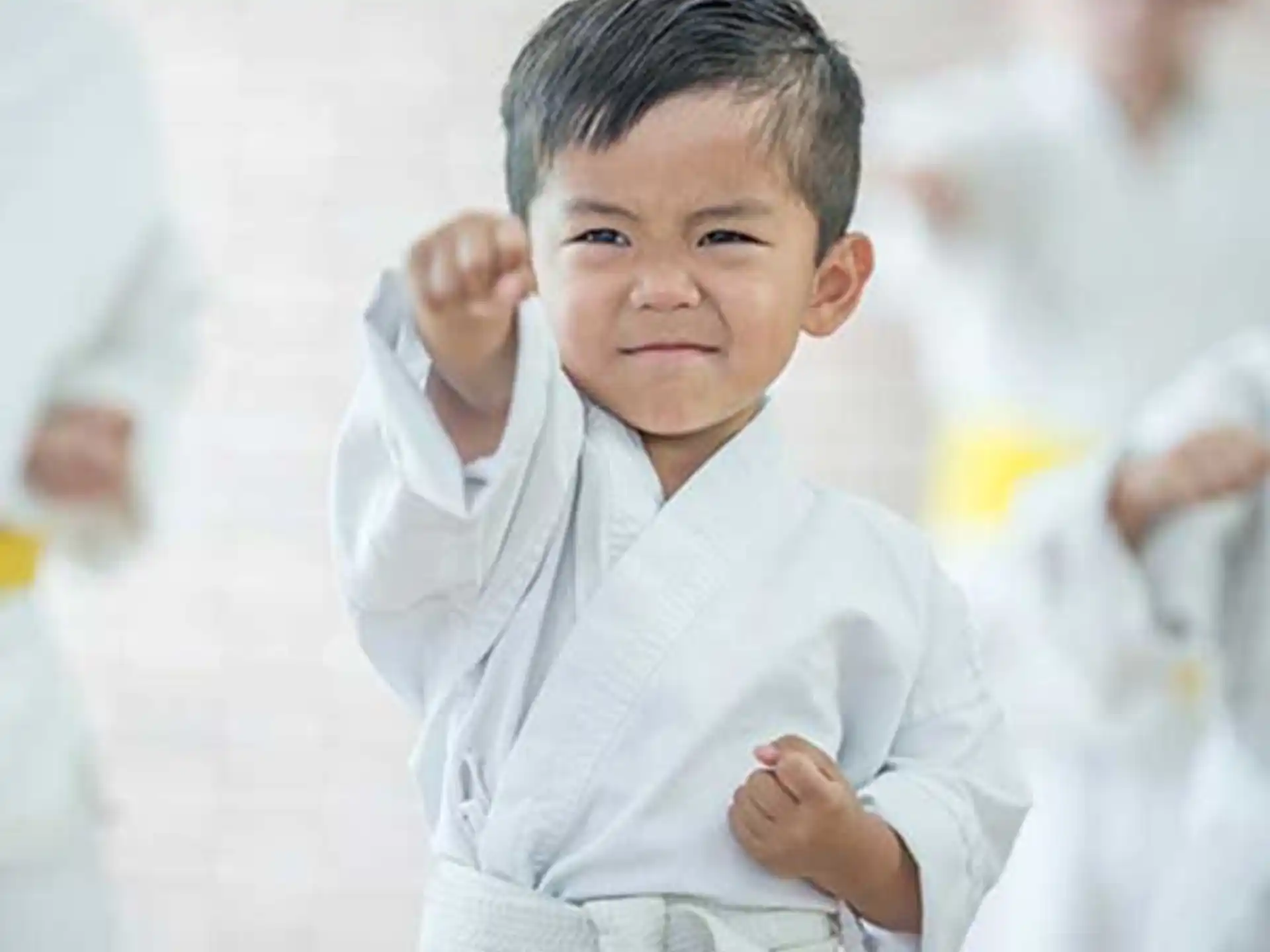 a young boy with his hands on his hips