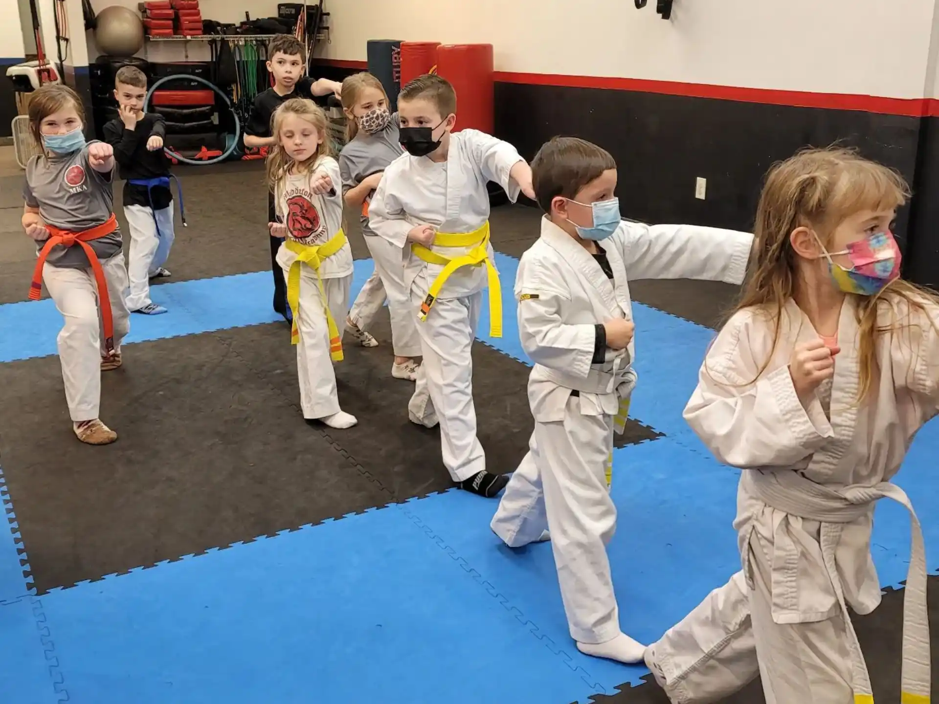 a group of people in white karate uniforms