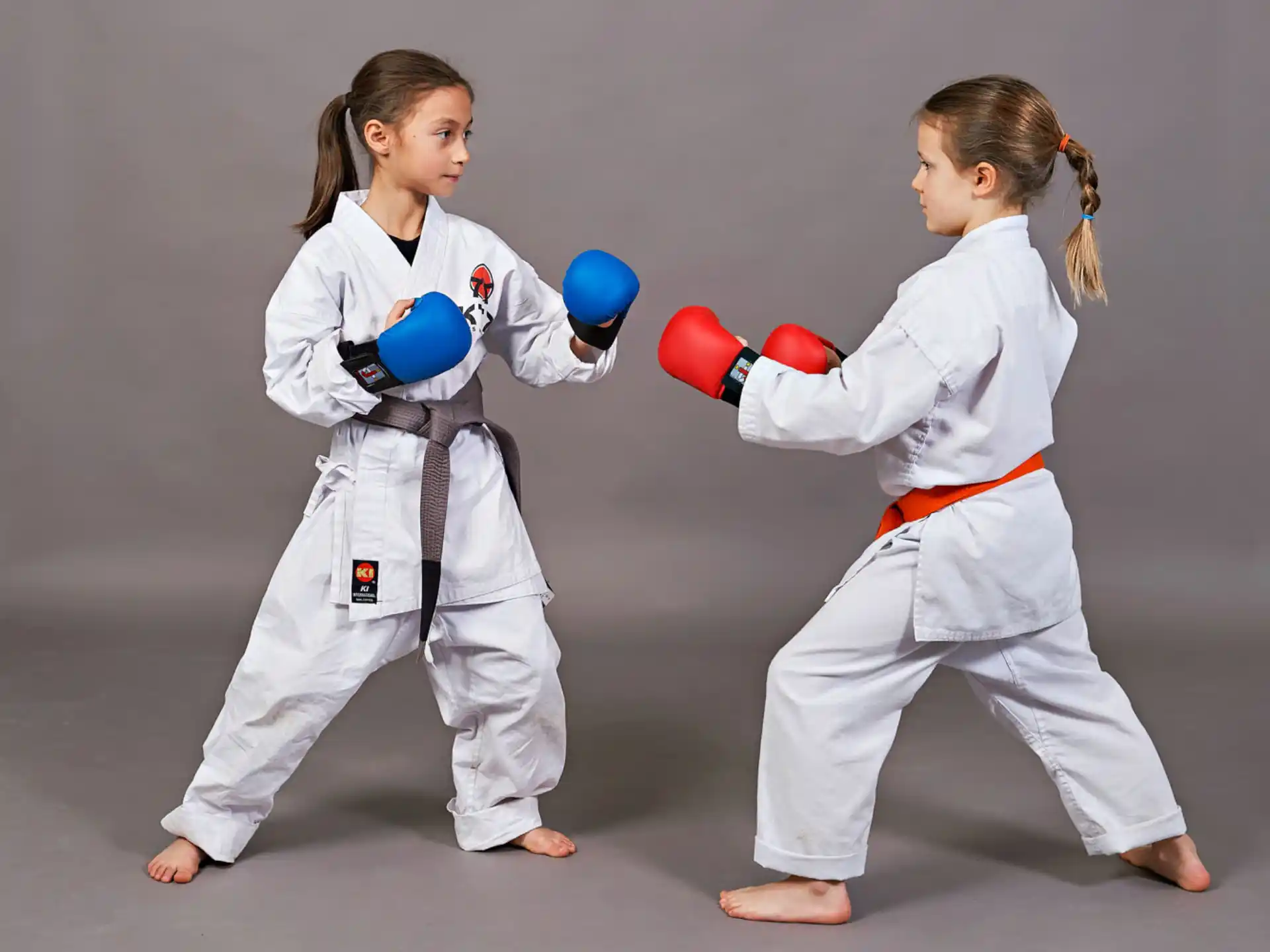 two girls in karate uniforms