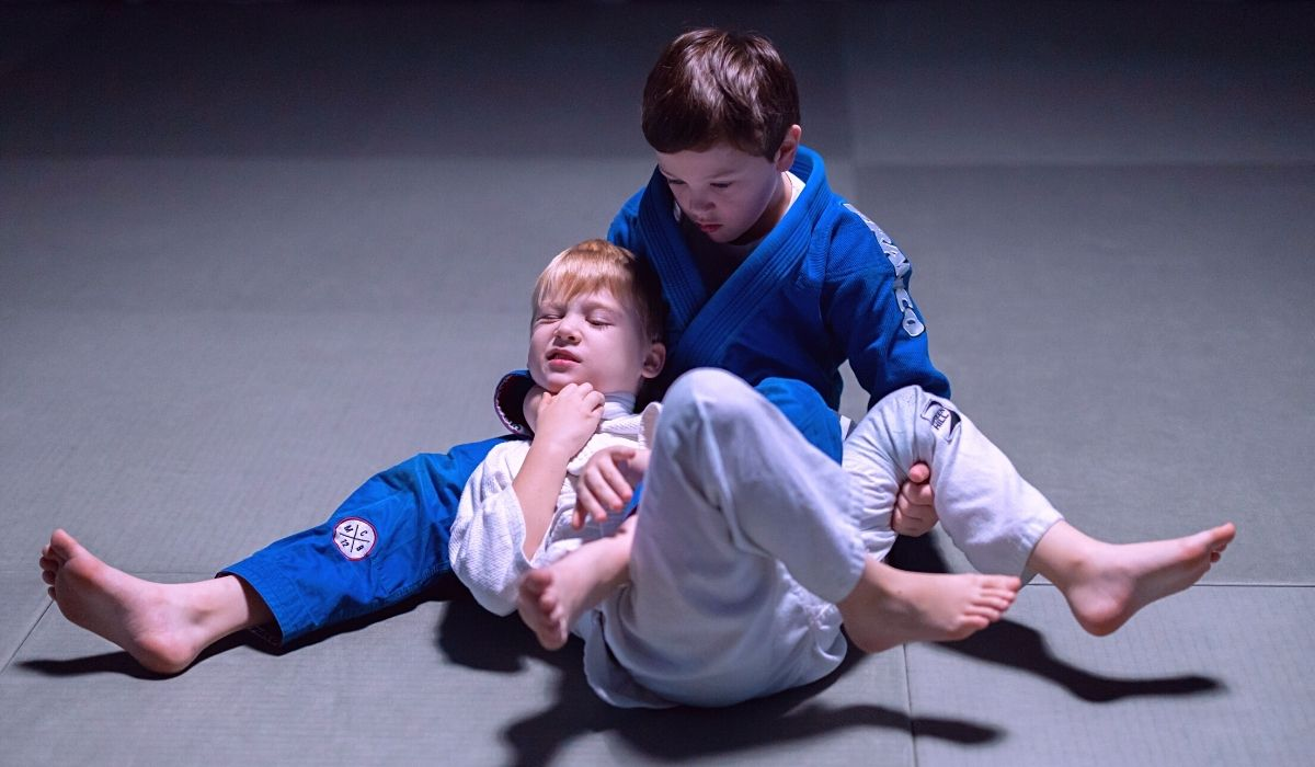 a boy and a girl lying on the ground