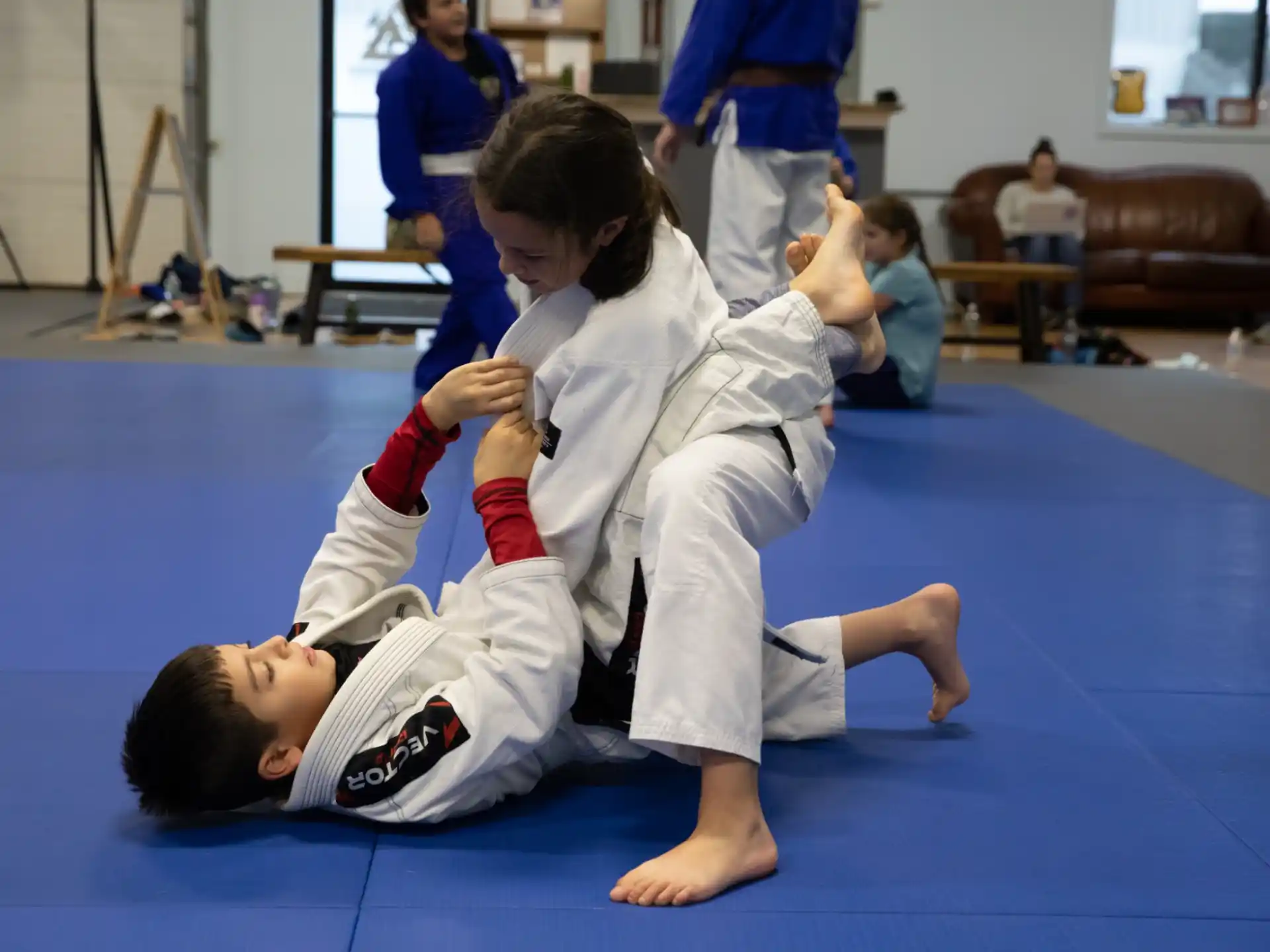 a boy and a girl in karate uniforms