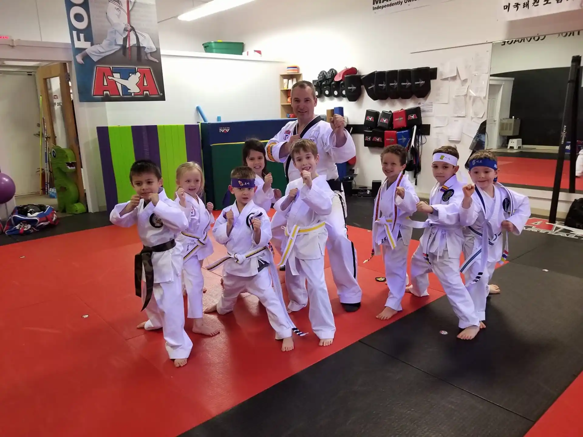 a group of children in white karate uniforms