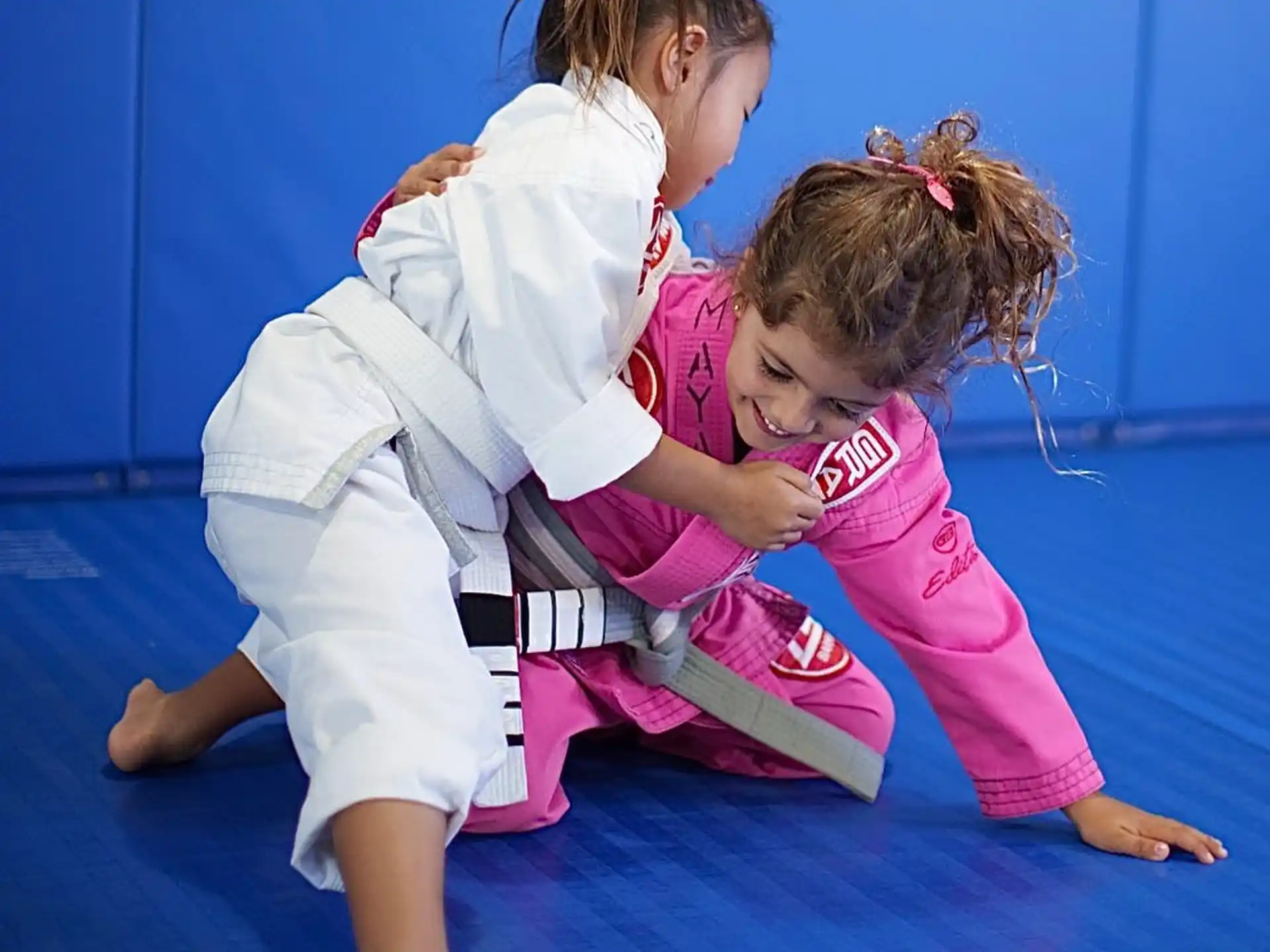 a couple of girls in karate uniforms