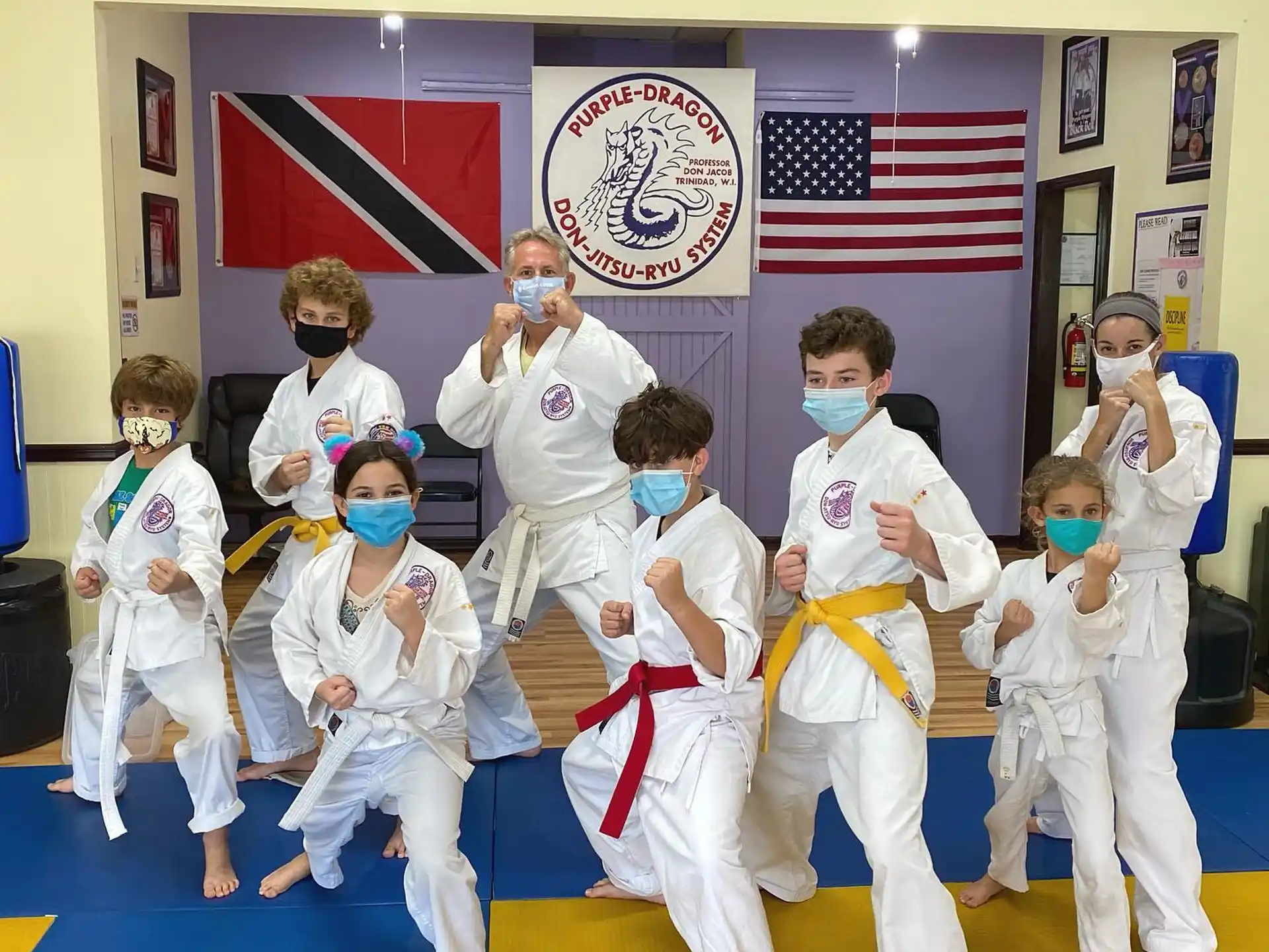 a group of kids in karate uniforms