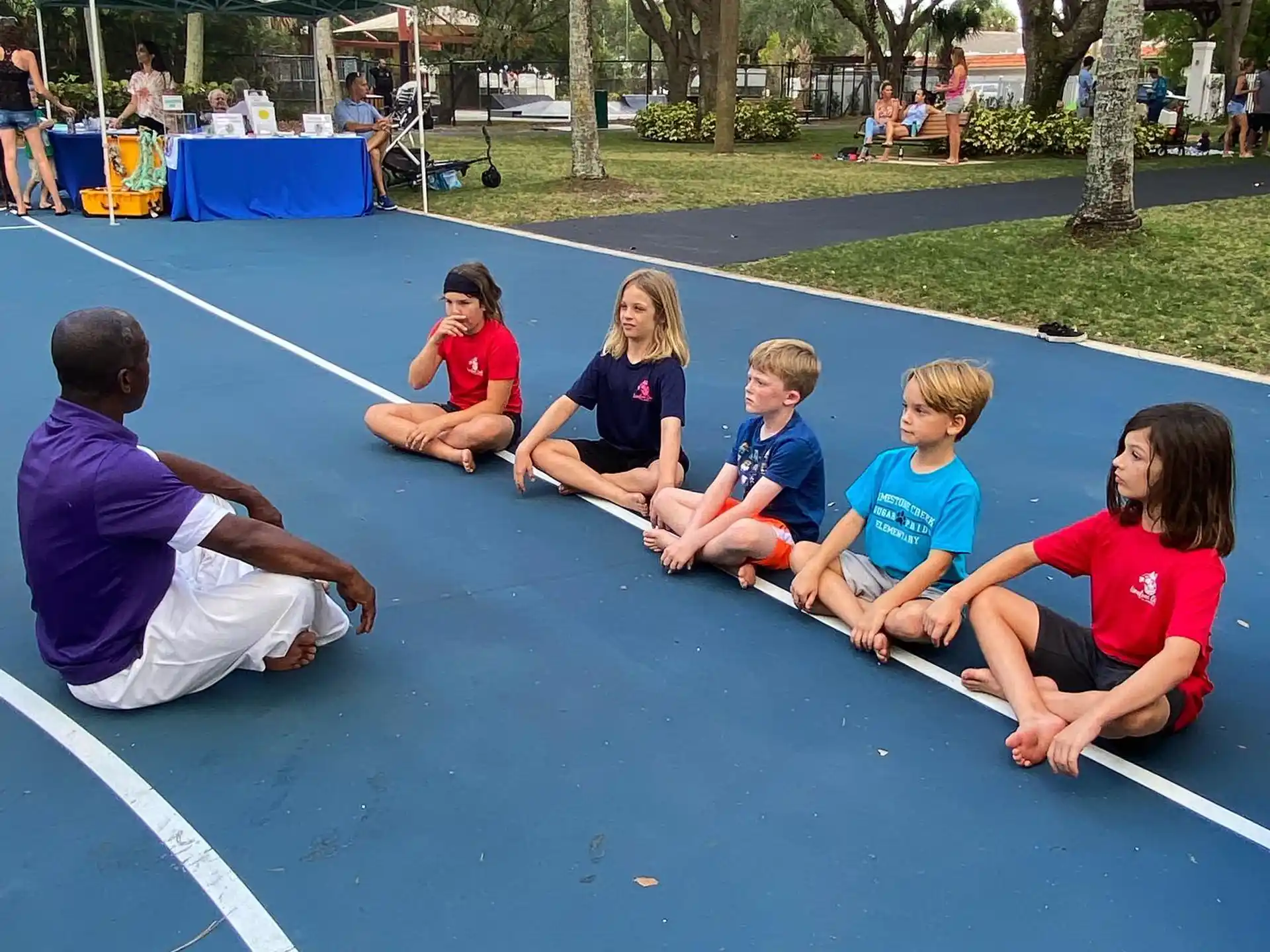 a group of people sitting on a mat on a mat