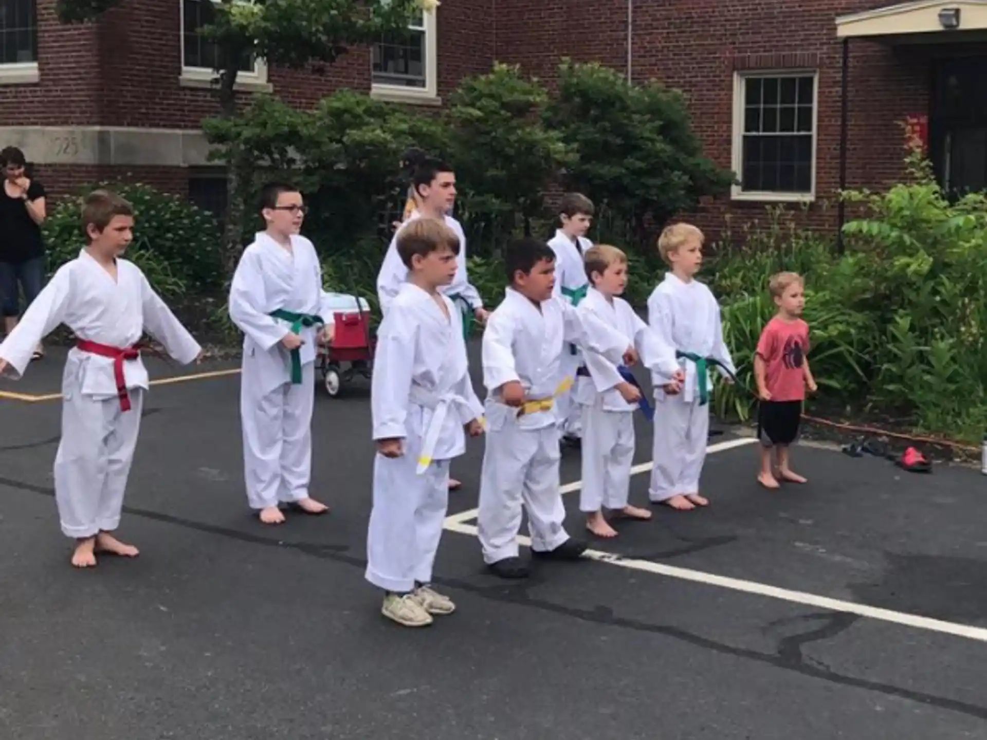 a group of children in white karate uniforms