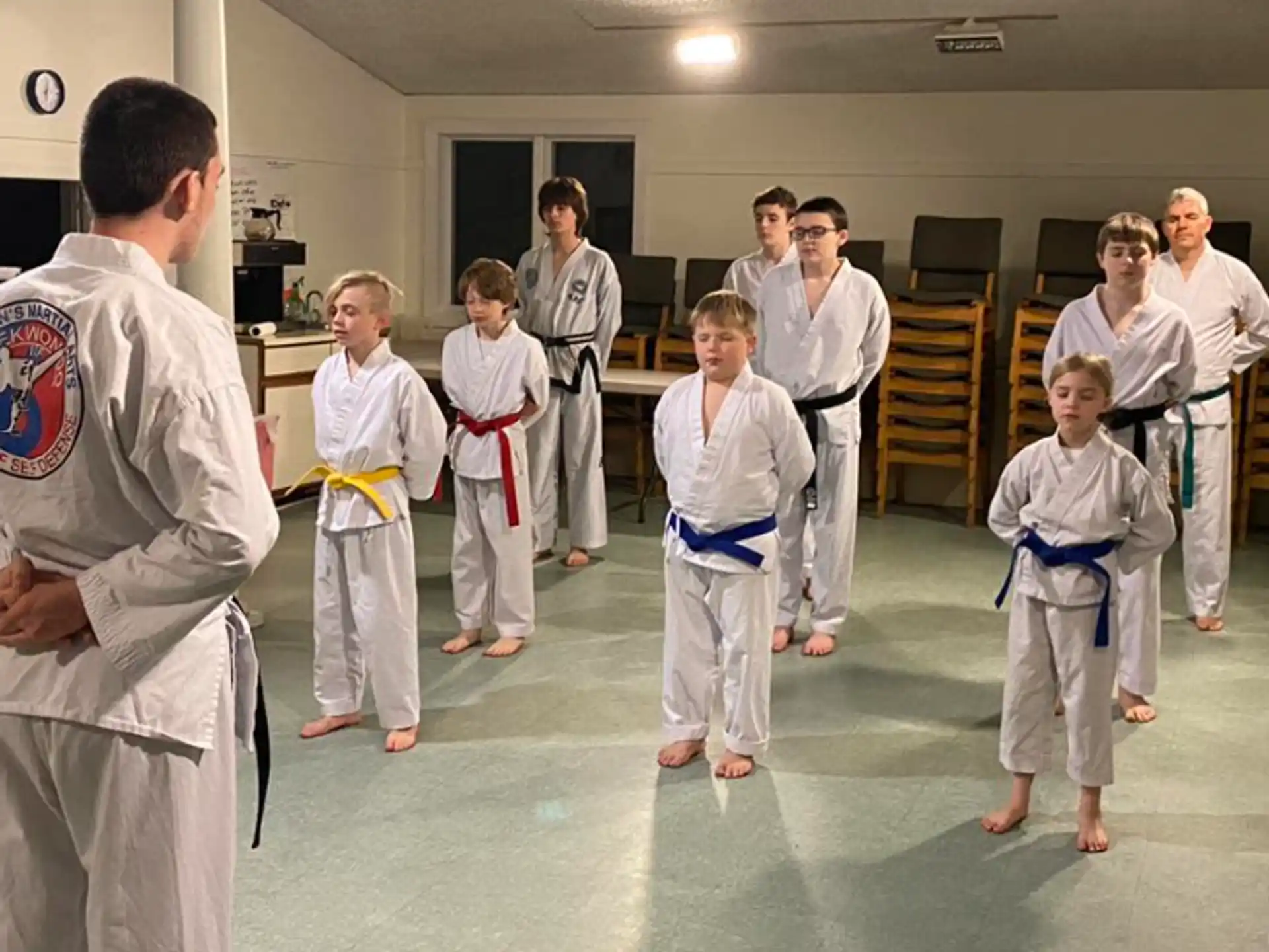 a group of people in karate uniforms