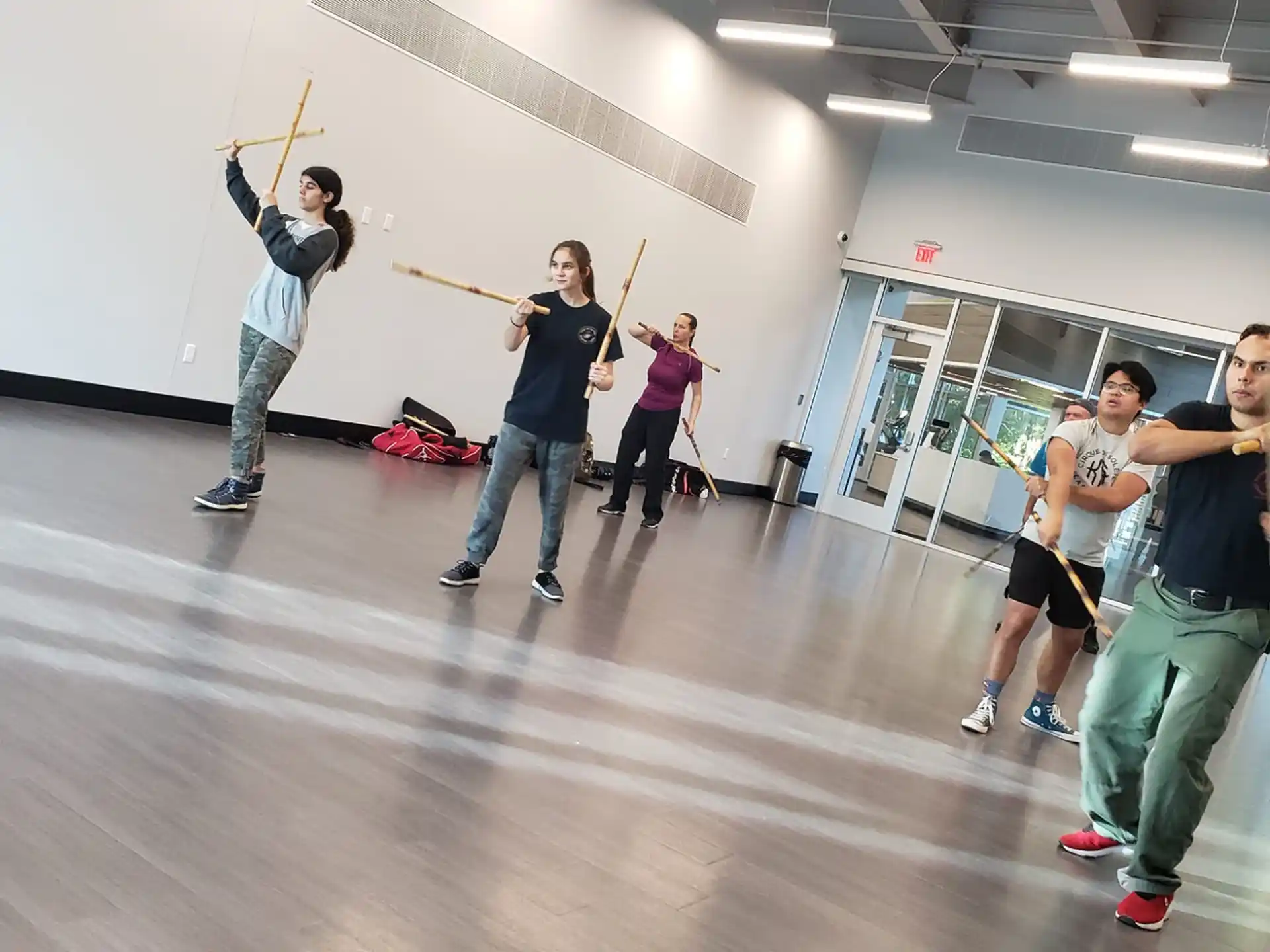 a group of people holding sticks