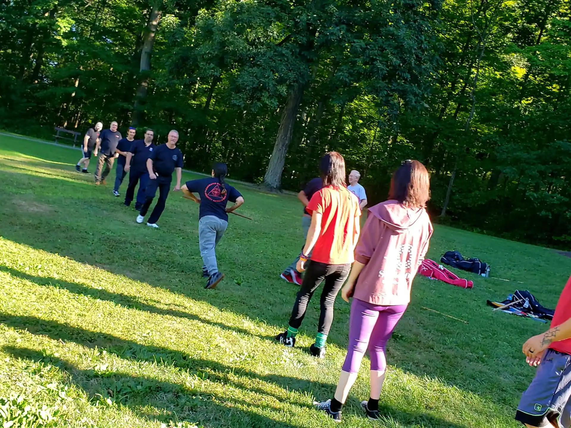 a group of people running on a grass field