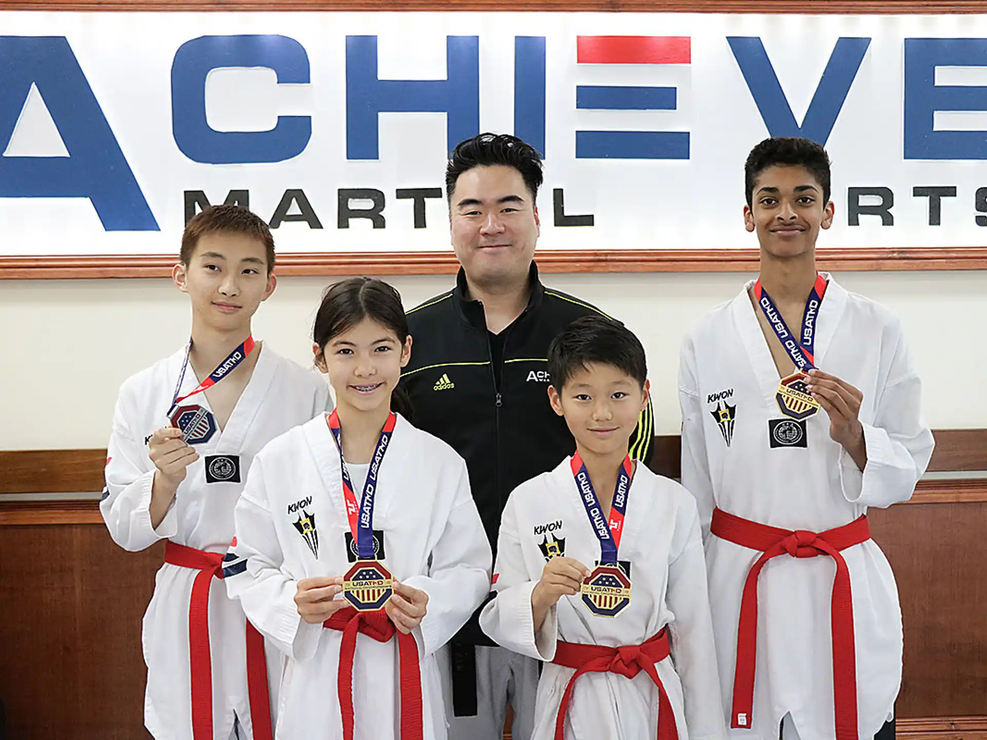 a group of boys wearing medals