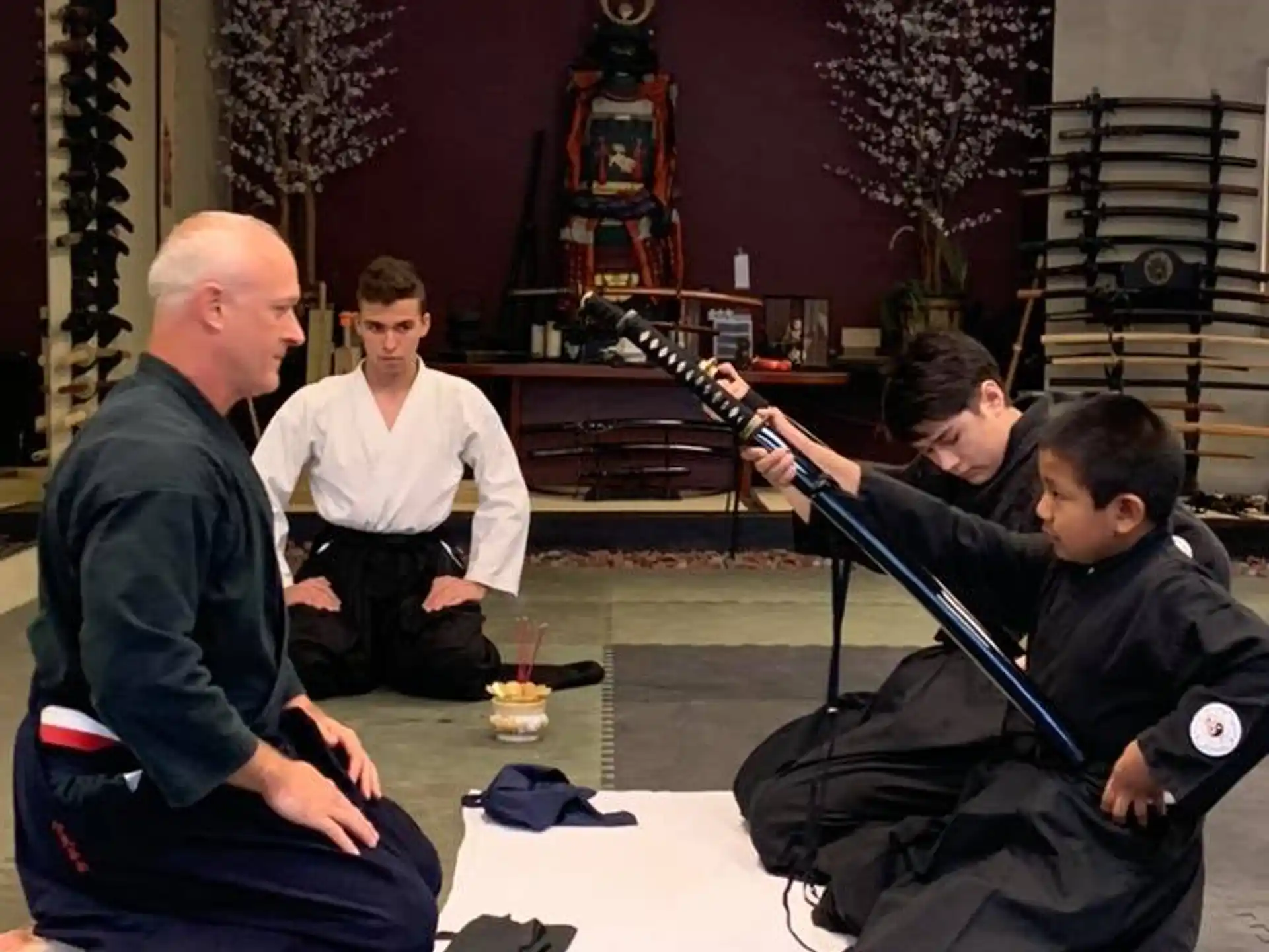a group of men sitting on the floor playing instruments