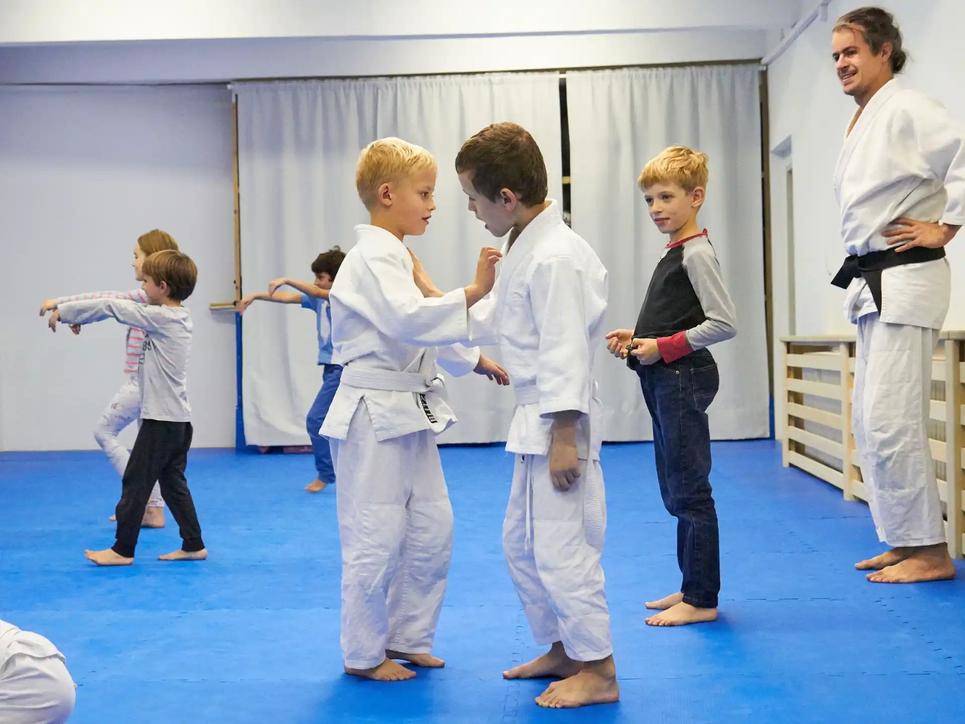 a group of people in karate uniforms