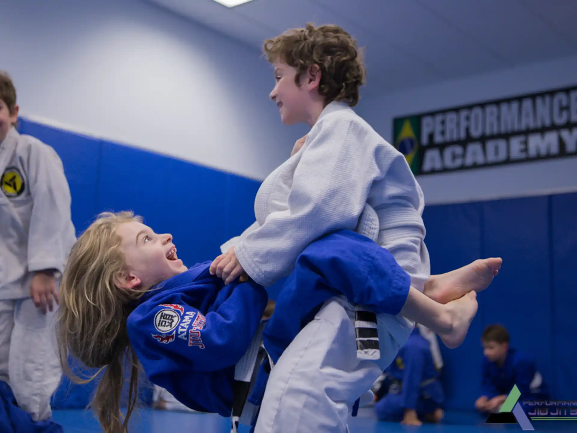 a woman holding a man in a karate uniform