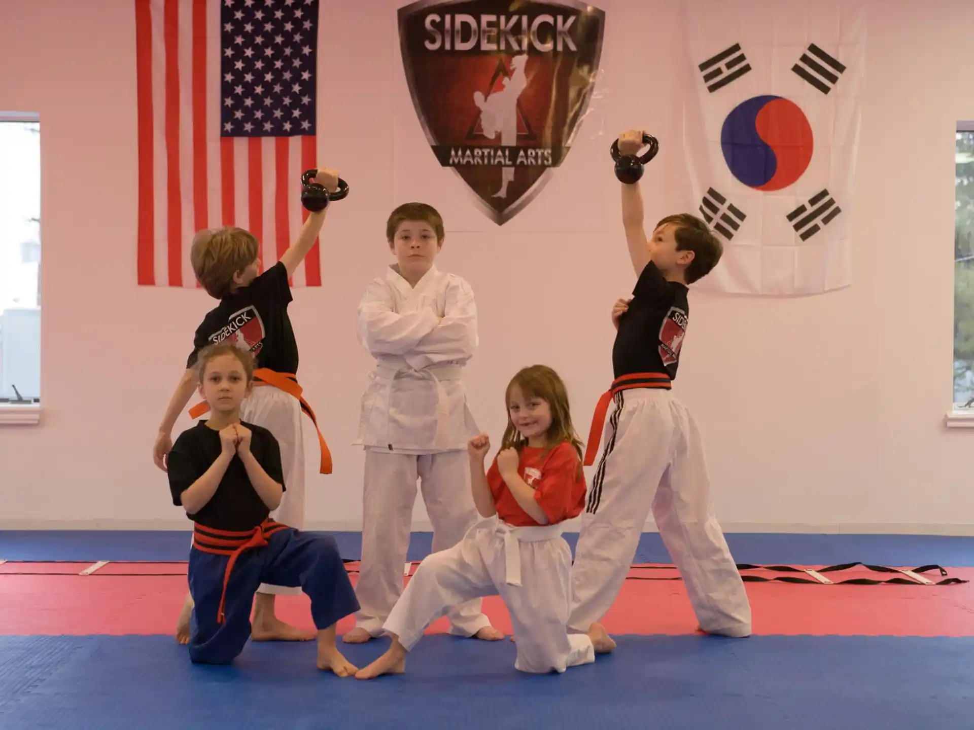 a group of children in karate uniforms