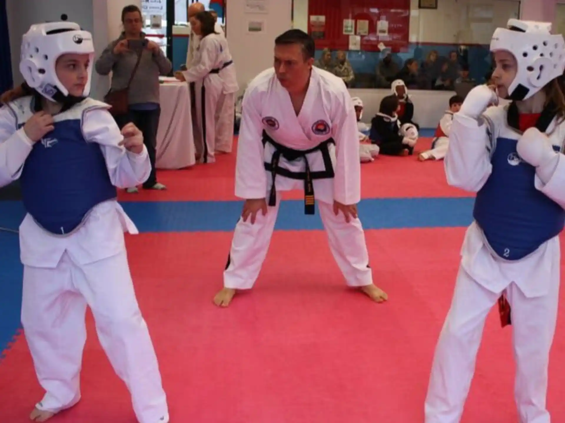 a group of people in white karate uniforms