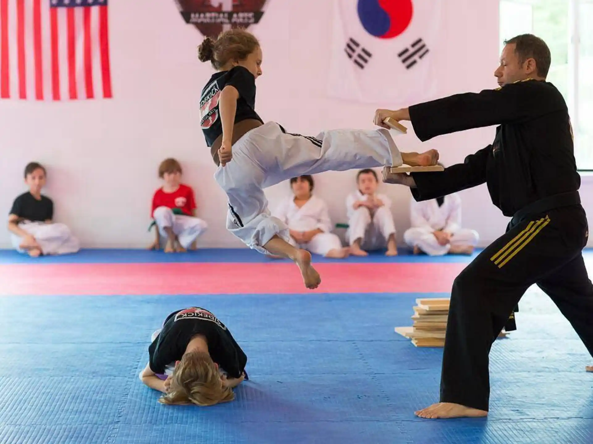 a man and a woman practicing martial arts