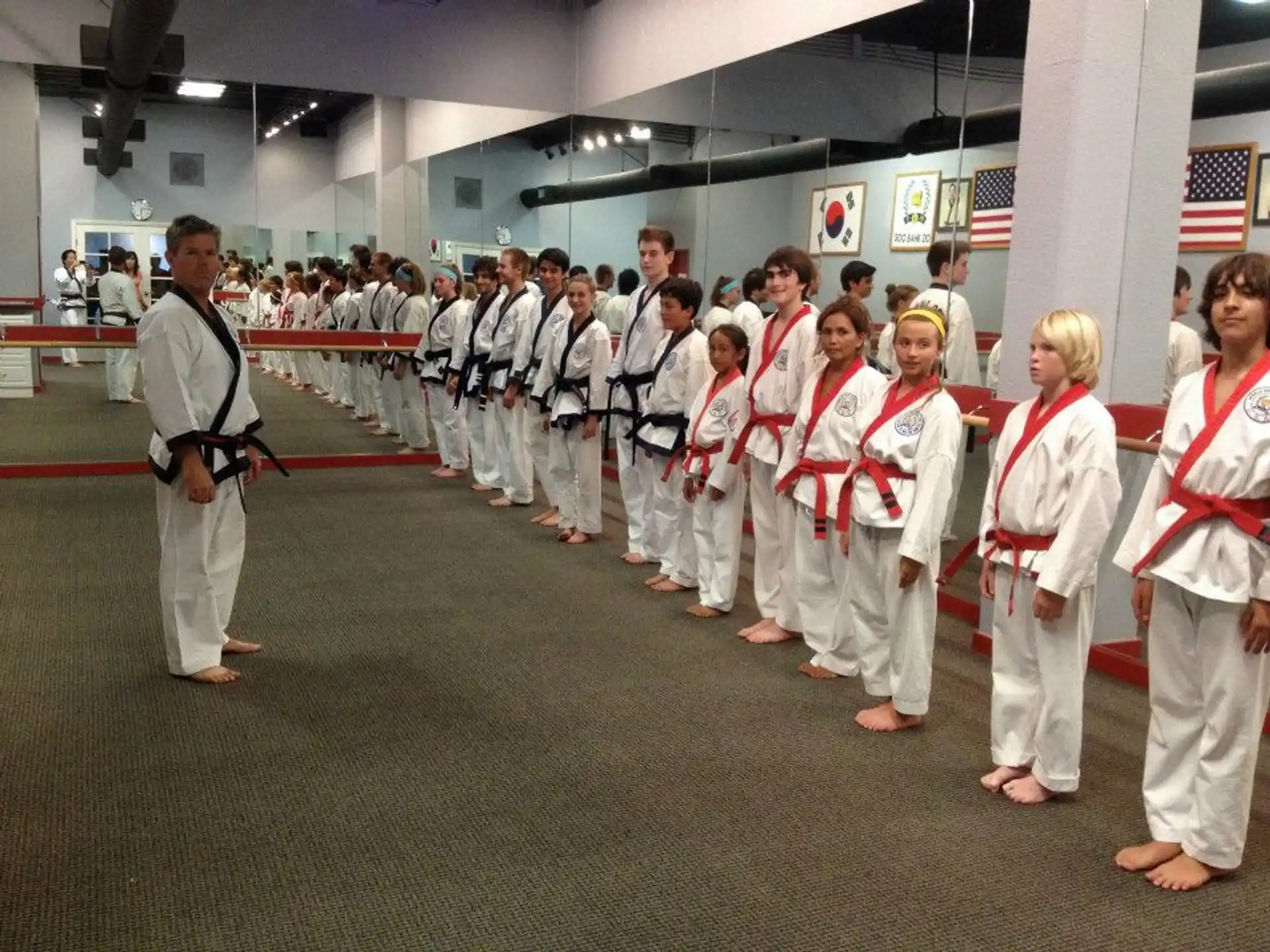 a group of people in white karate uniforms