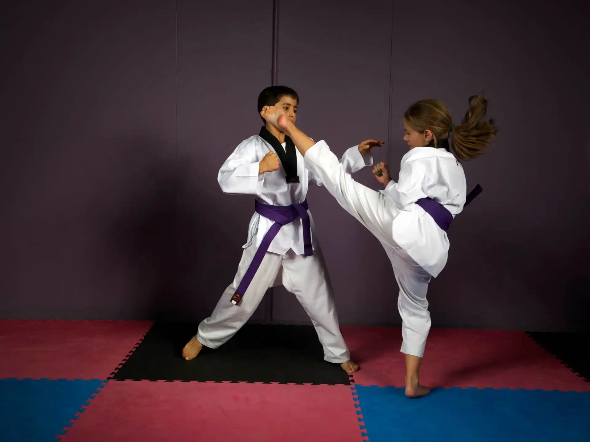 a man and woman in karate uniforms