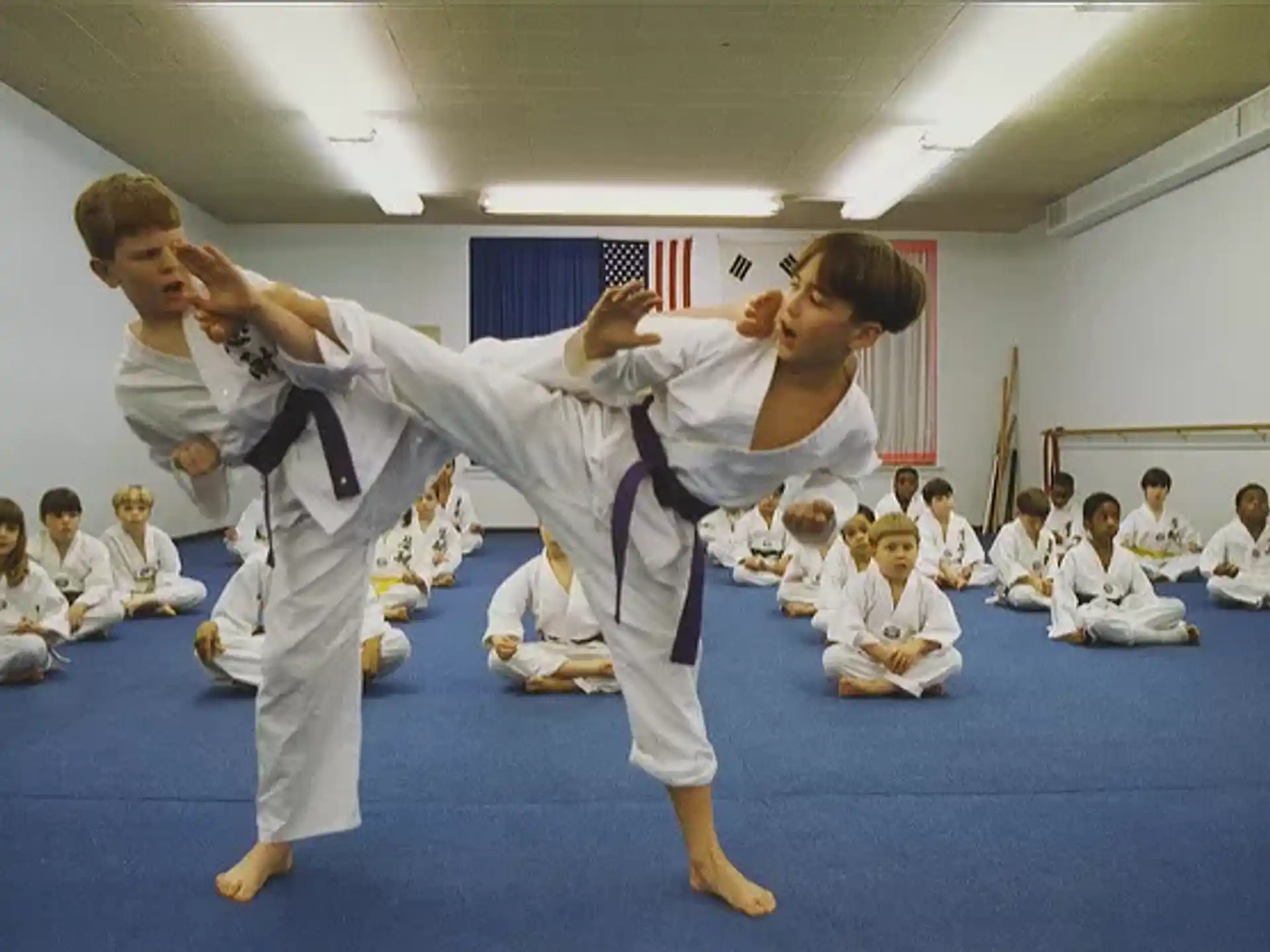 a group of children in karate uniforms