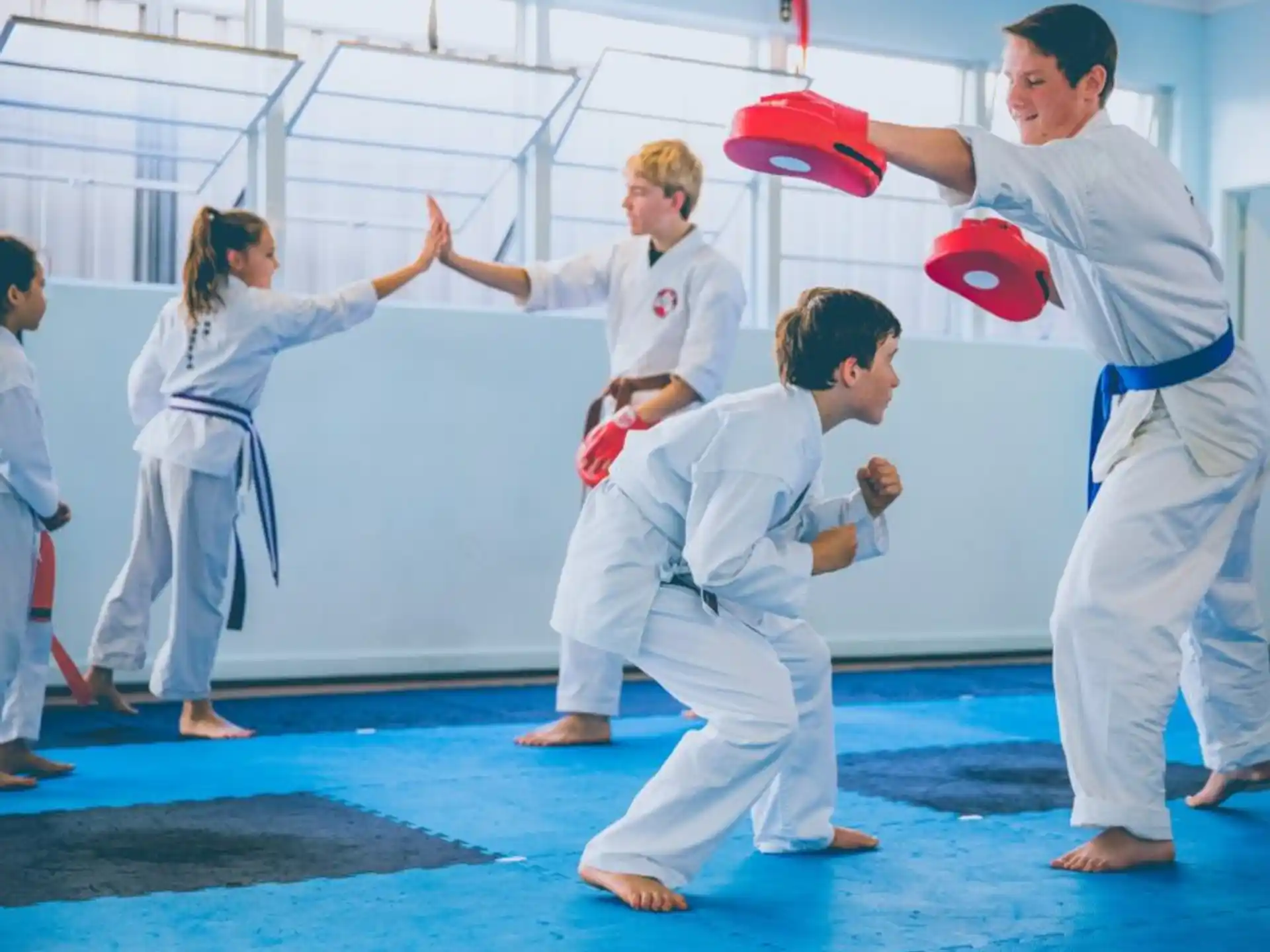 a group of people in karate uniforms