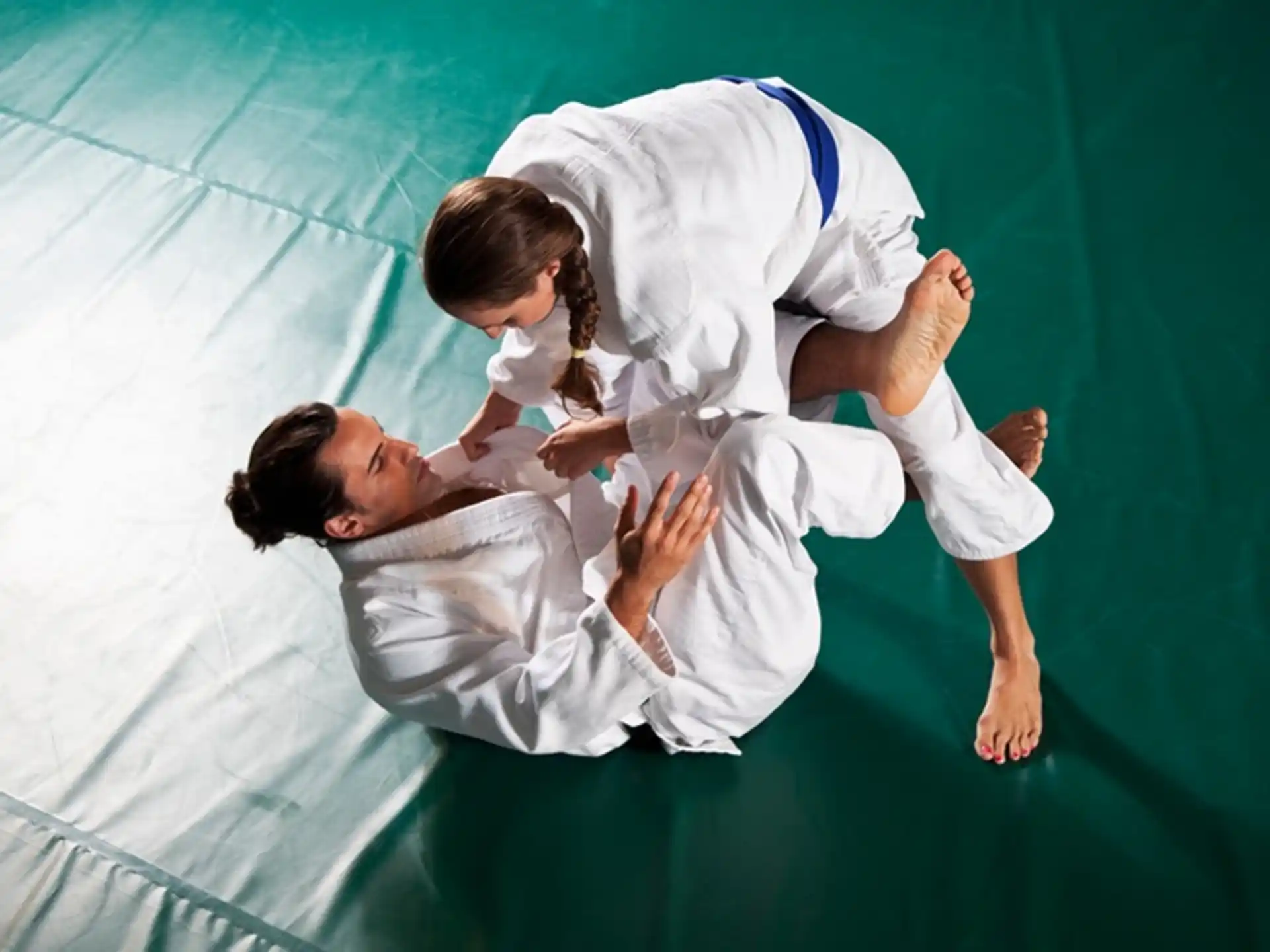 a man and a woman in karate uniforms