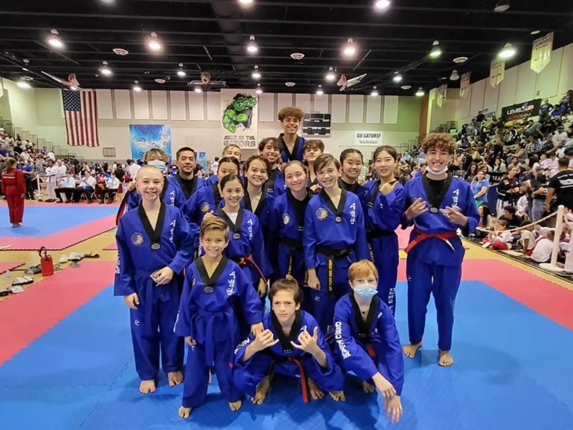 a group of children in blue karate uniforms posing for a photo