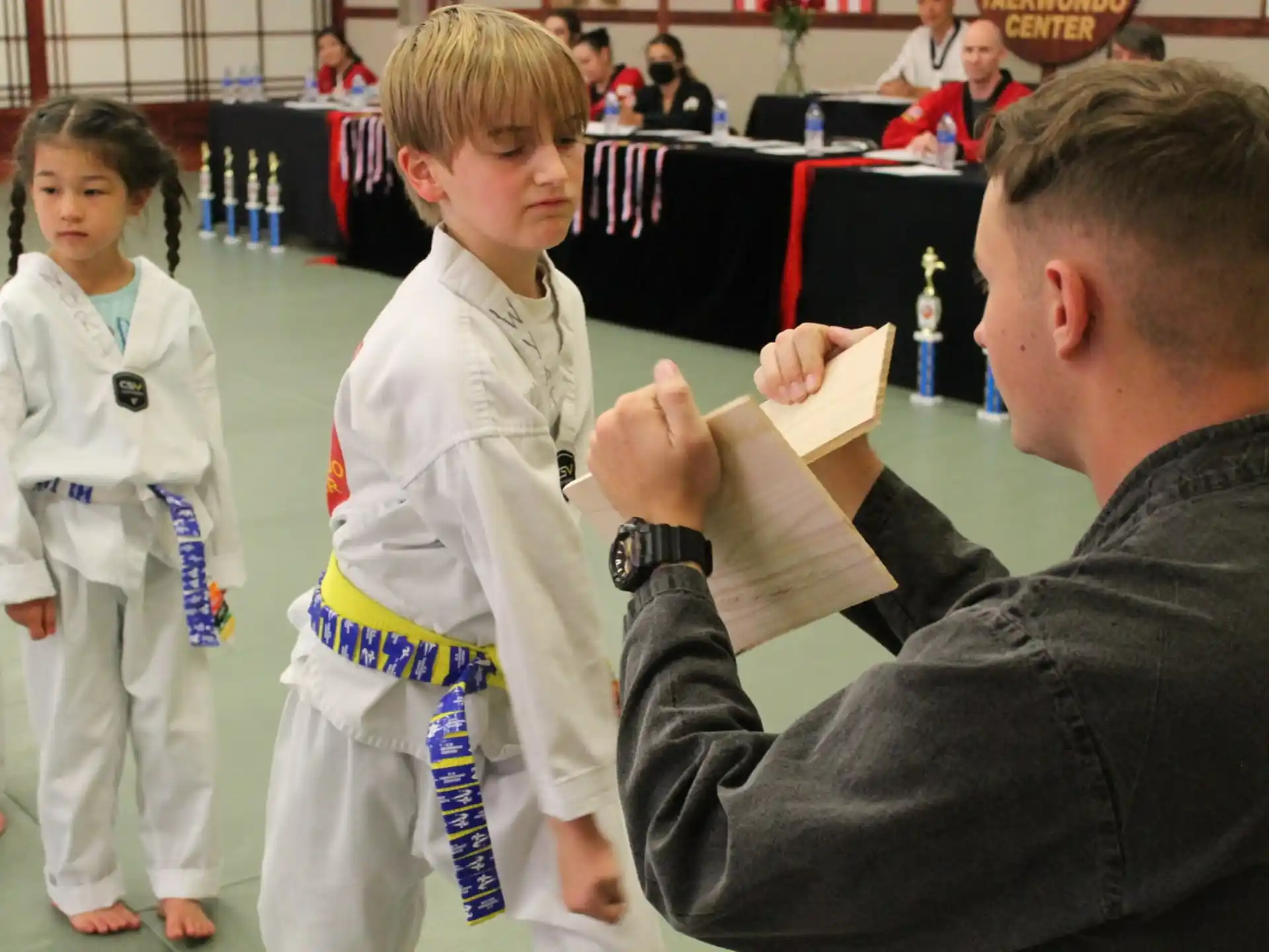 a man in a suit and a woman in a karate uniform