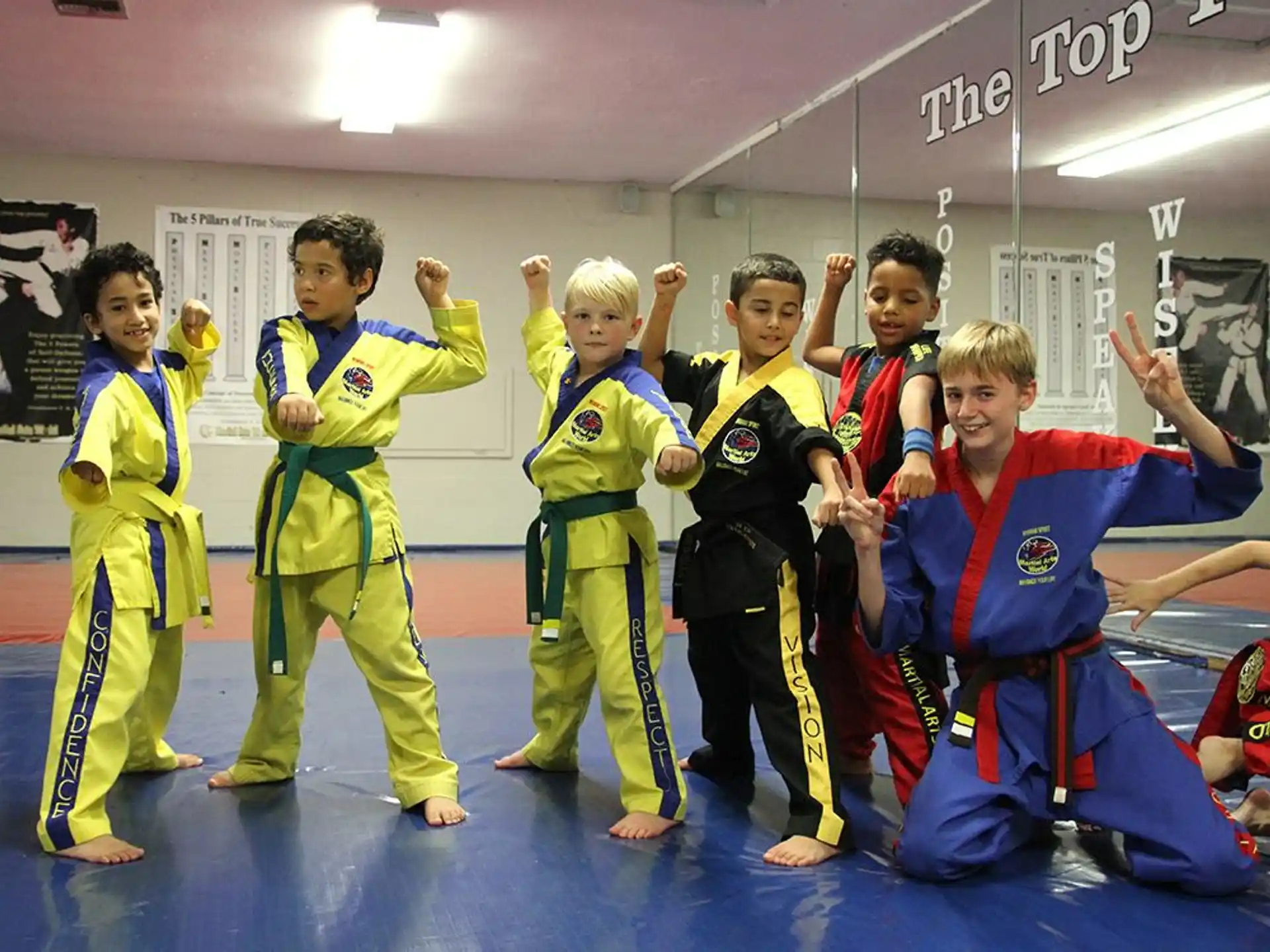 a group of kids in karate uniforms