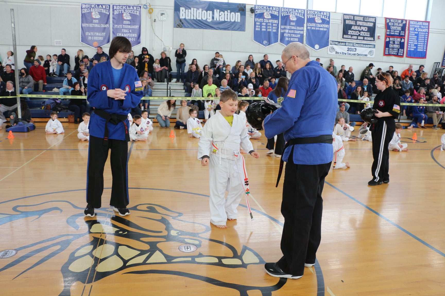 a person and a boy in a gym