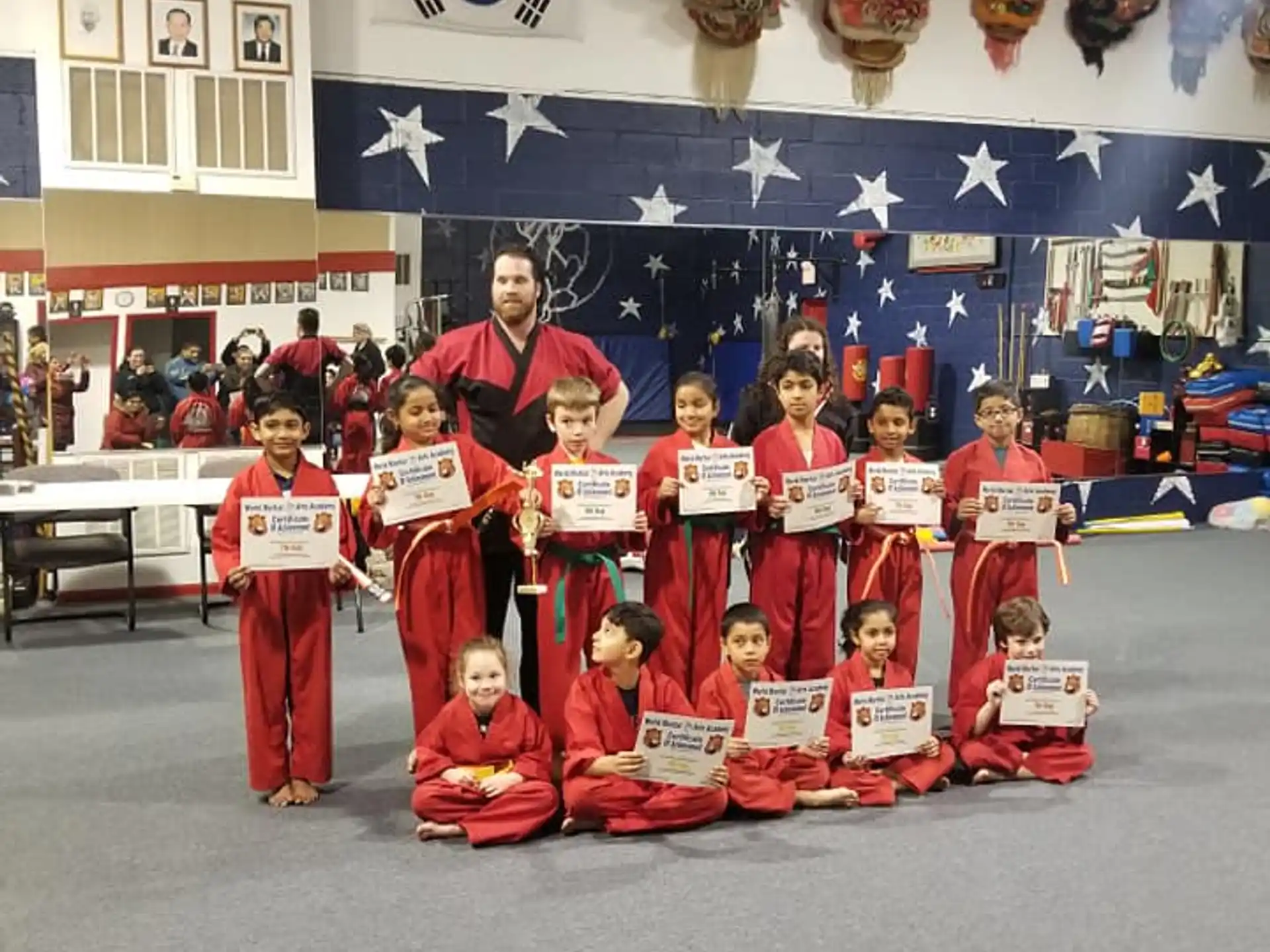 a group of children in red uniforms