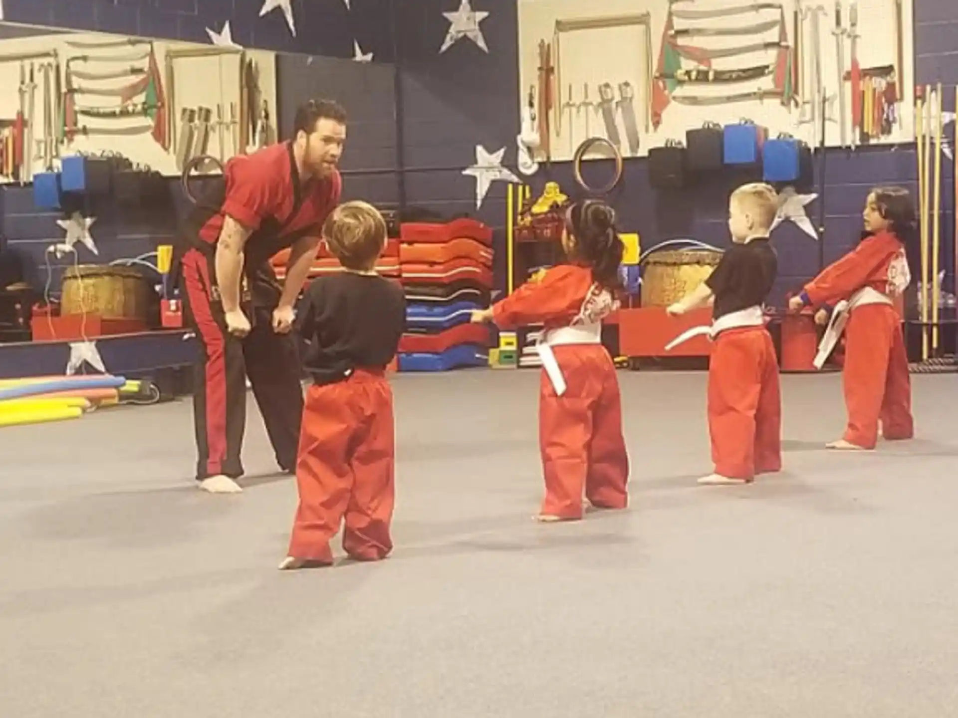 a group of people in red jumpsuits in a room