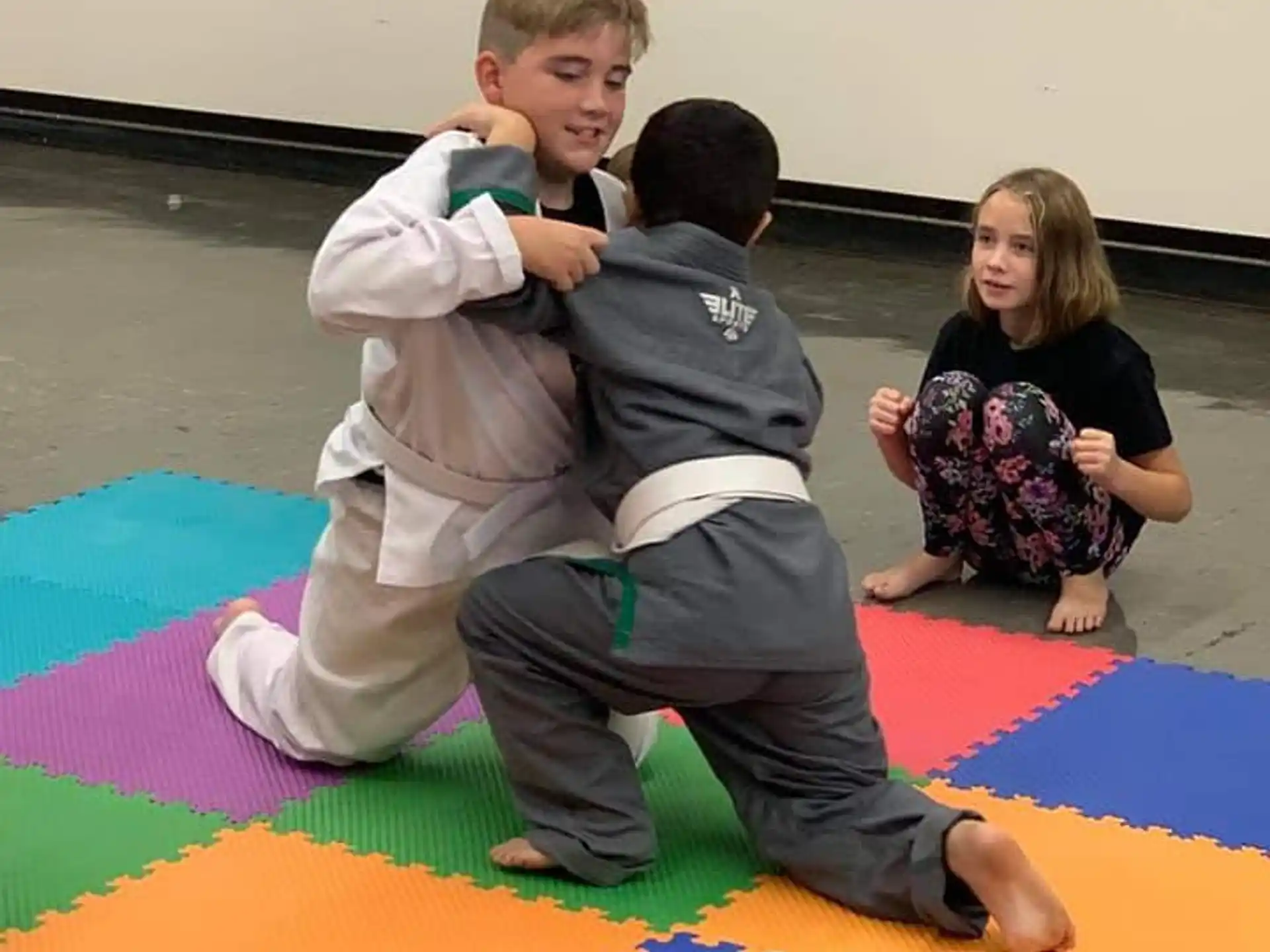 a group of children sitting on a mat on a mat