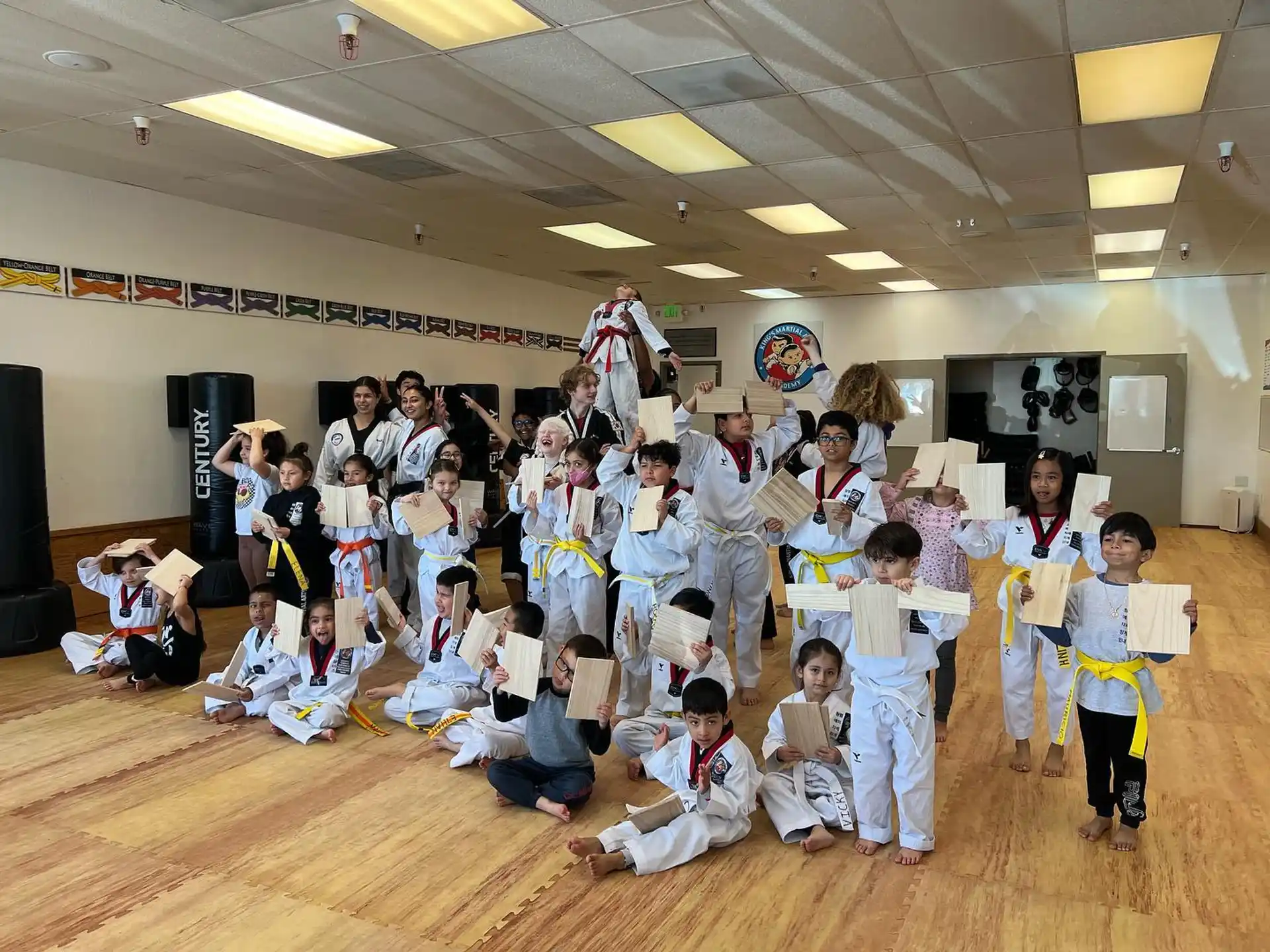a group of children in karate uniforms