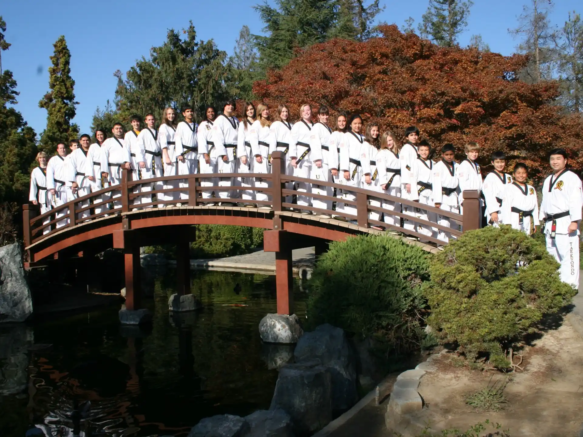 a group of people standing on a bridge over a river