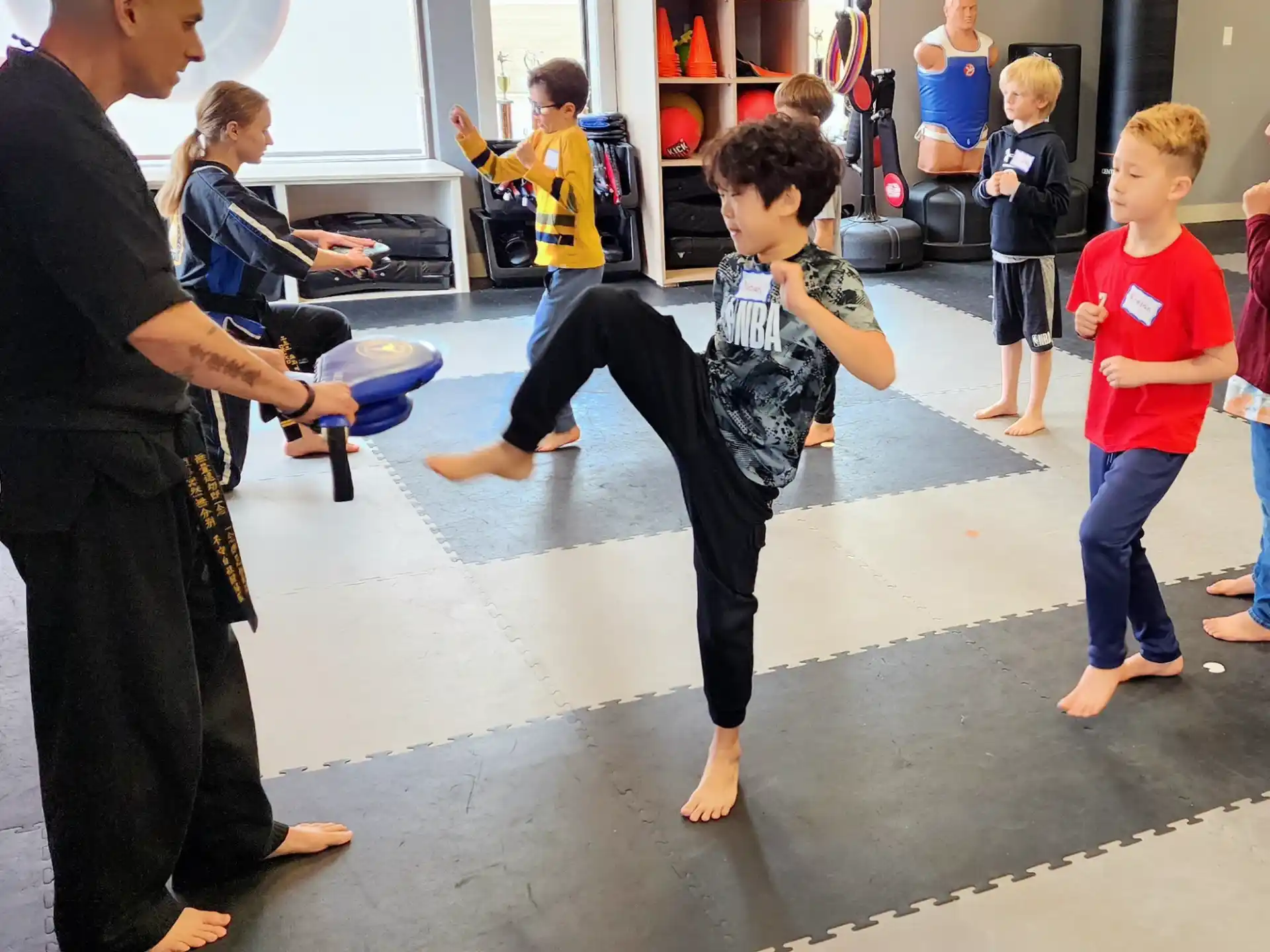 a person kicking a boy in the air