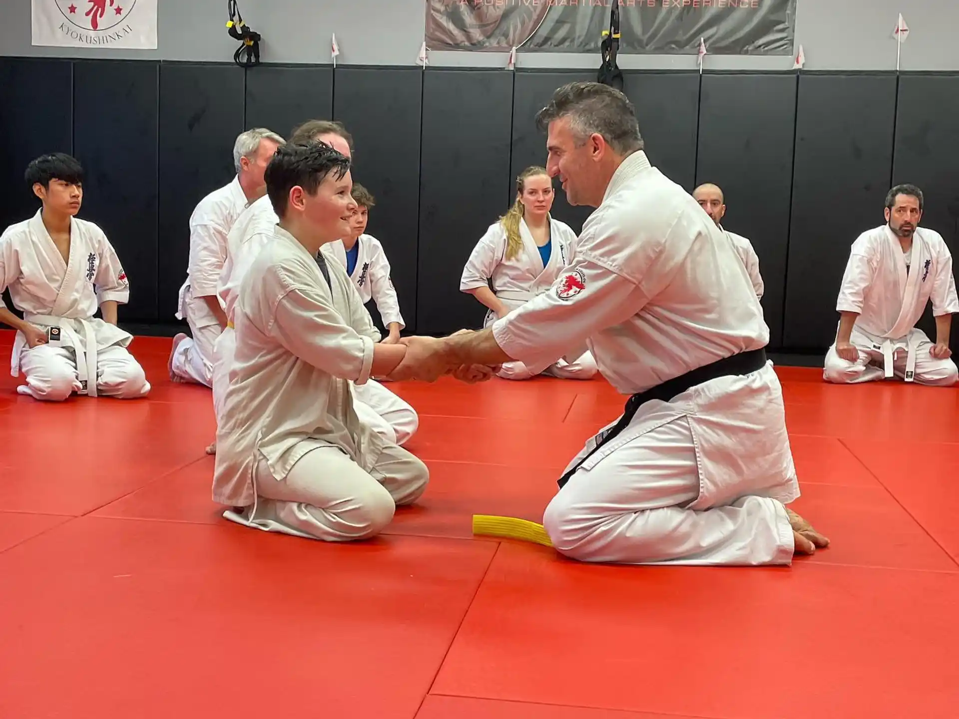 a group of people in karate uniforms